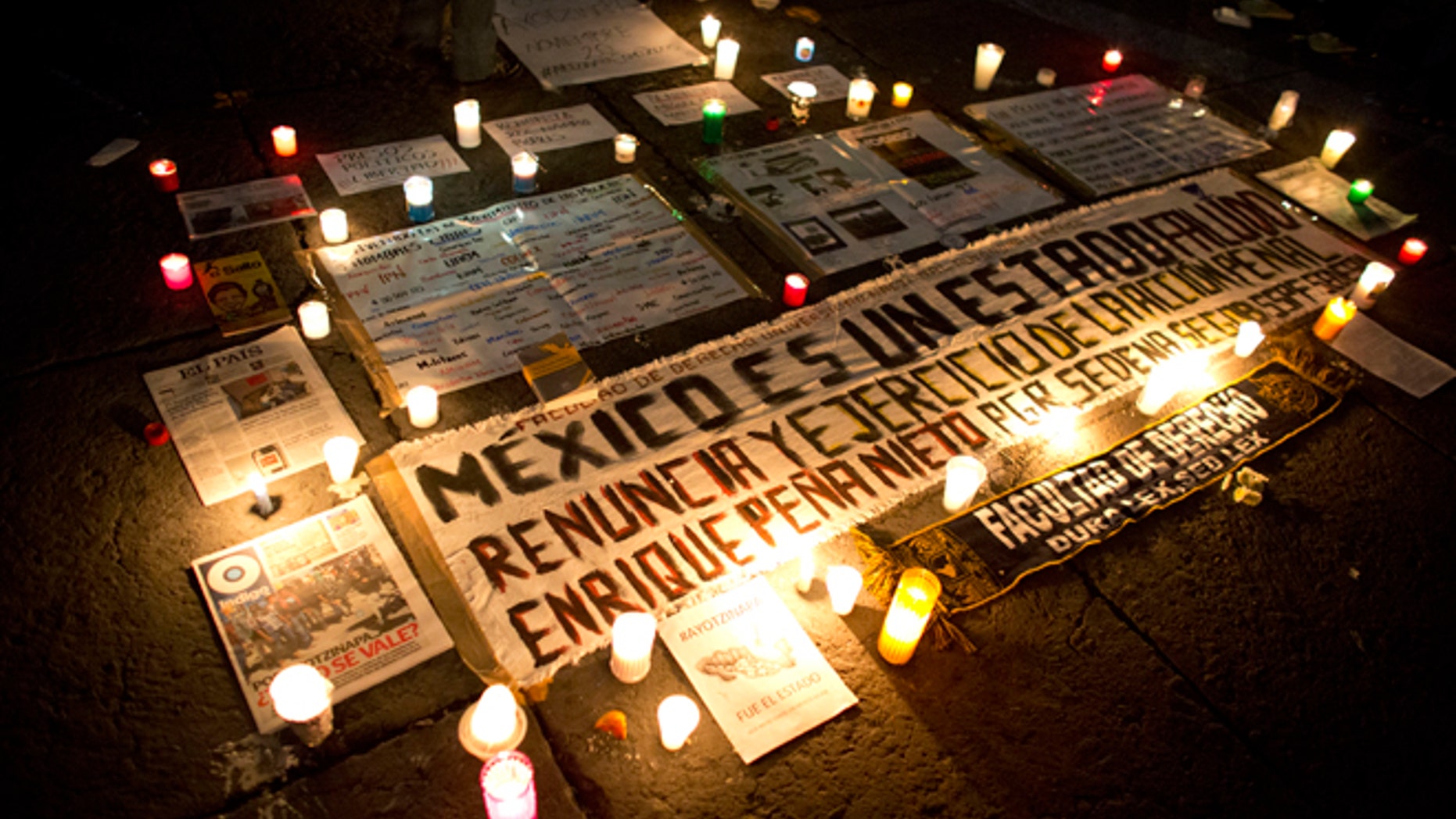 Candles surround protest signs carried by demonstrators in a march against the disappearance of 43 college students. Protesters marched in Mexico City to demand authorities find the missing students.
(AP Photo/Rebecca Blackwell)