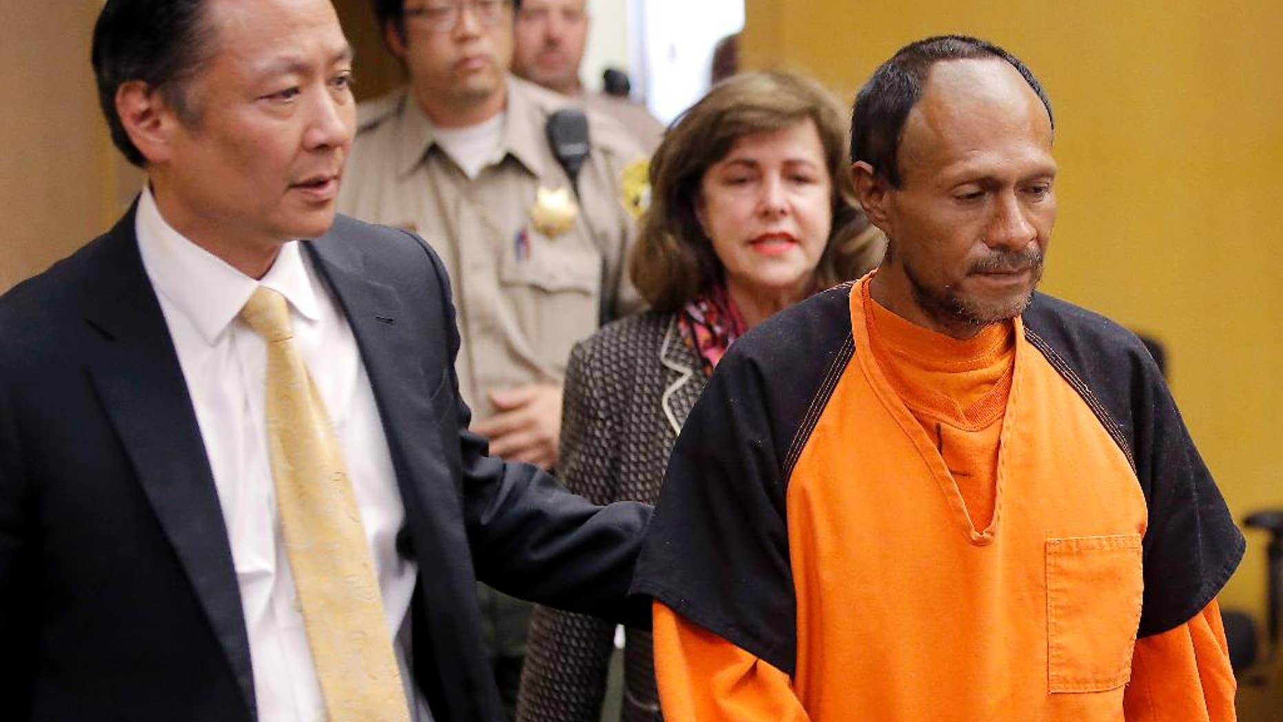 FILE - In this July 7, 2015 file photo, Juan Francisco Lopez-Sanchez, right, is lead into the courtroom by San Francisco Public Defender Jeff Adachi, left, and Assistant District Attorney Diana Garciaor, center, for his arraignment at the Hall of Justice in San Francisco. Even if the suspect at the center of a national immigration debate accidentally fired the shot that killed Kate Steinle on San Francisco's Pier 14, on July 1, it may not help his case. (Michael Macor/San Francisco Chronicle via AP, Pool, File)