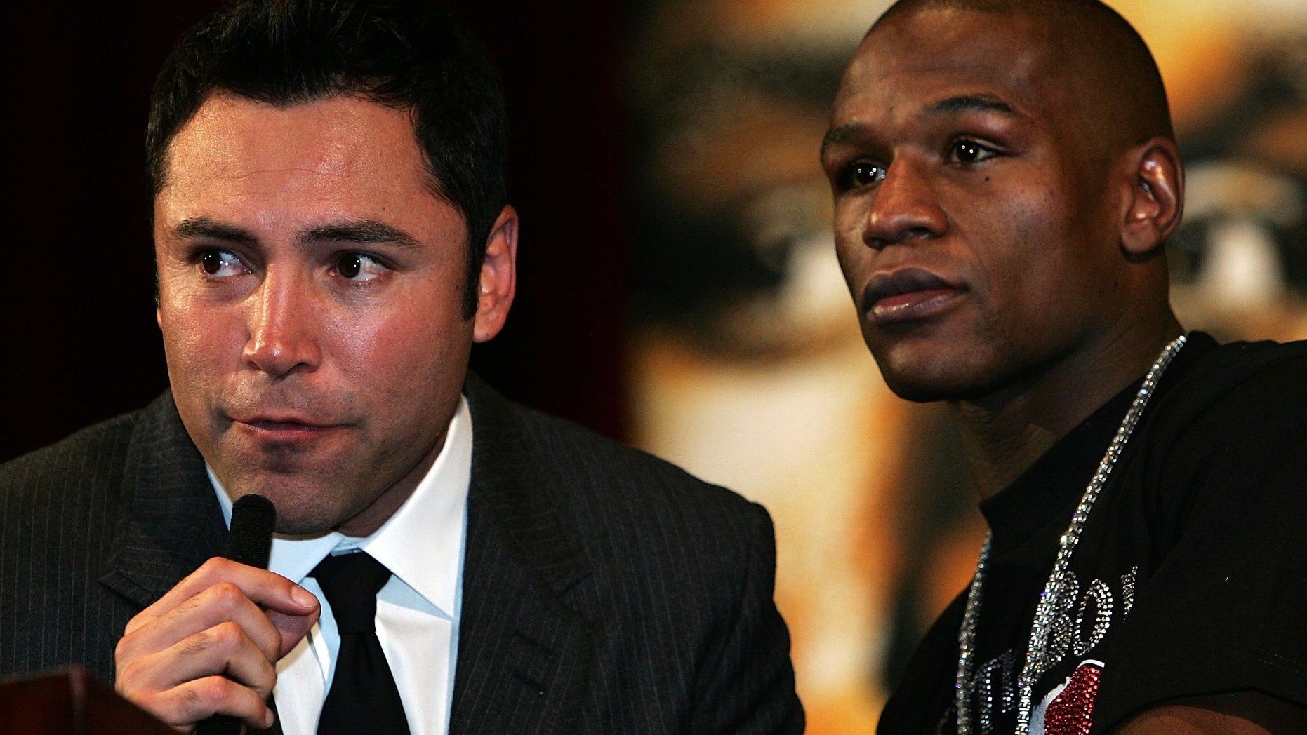 Promoter Oscar De La Hoya speaks alongside Floyd Mayweather Jr. (Photo by John Gichigi/Getty Images)