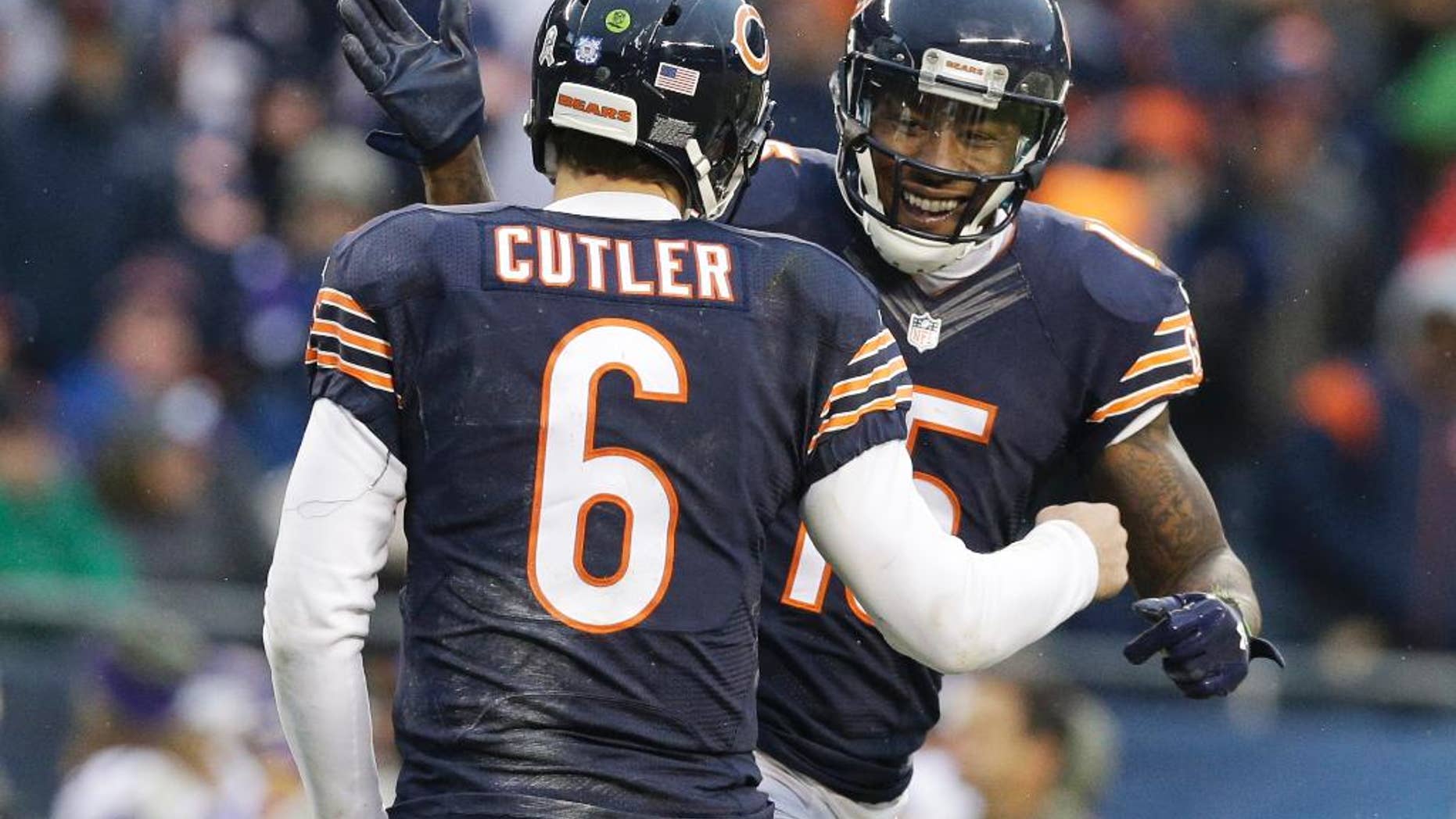 Chicago Bears receiver Brandon Marshall (15) celebrates his touchdown reception with quarterback Jay Cutler (6) during the second half of an NFL football game against the Minnesota Vikings Sunday, Nov. 16, 2014 in Chicago. (AP Photo/Nam Y. Huh)