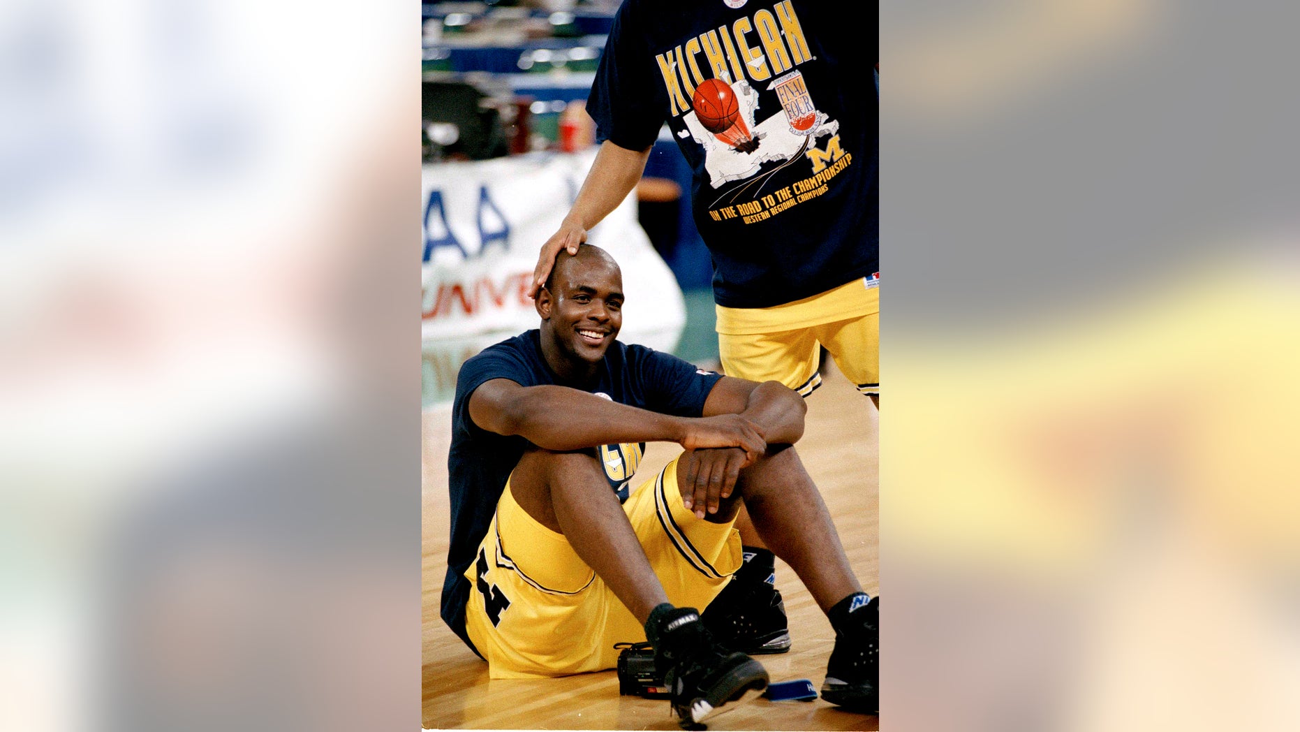 FILE - Michigan's Chris Webber gets a pat on the head after being named MVP of the NCAA West regional final in Seattle, Wa., in this March 29, 1993 file photo. Michigan’s 10-year, NCAA-issued dissociation from Webber, Taylor, Bullock ends. On Wednesday, May 8, 2013 the school and the former basketball players can renew their relationship if they choose. (AP Photo/Susan Ragan, File)
