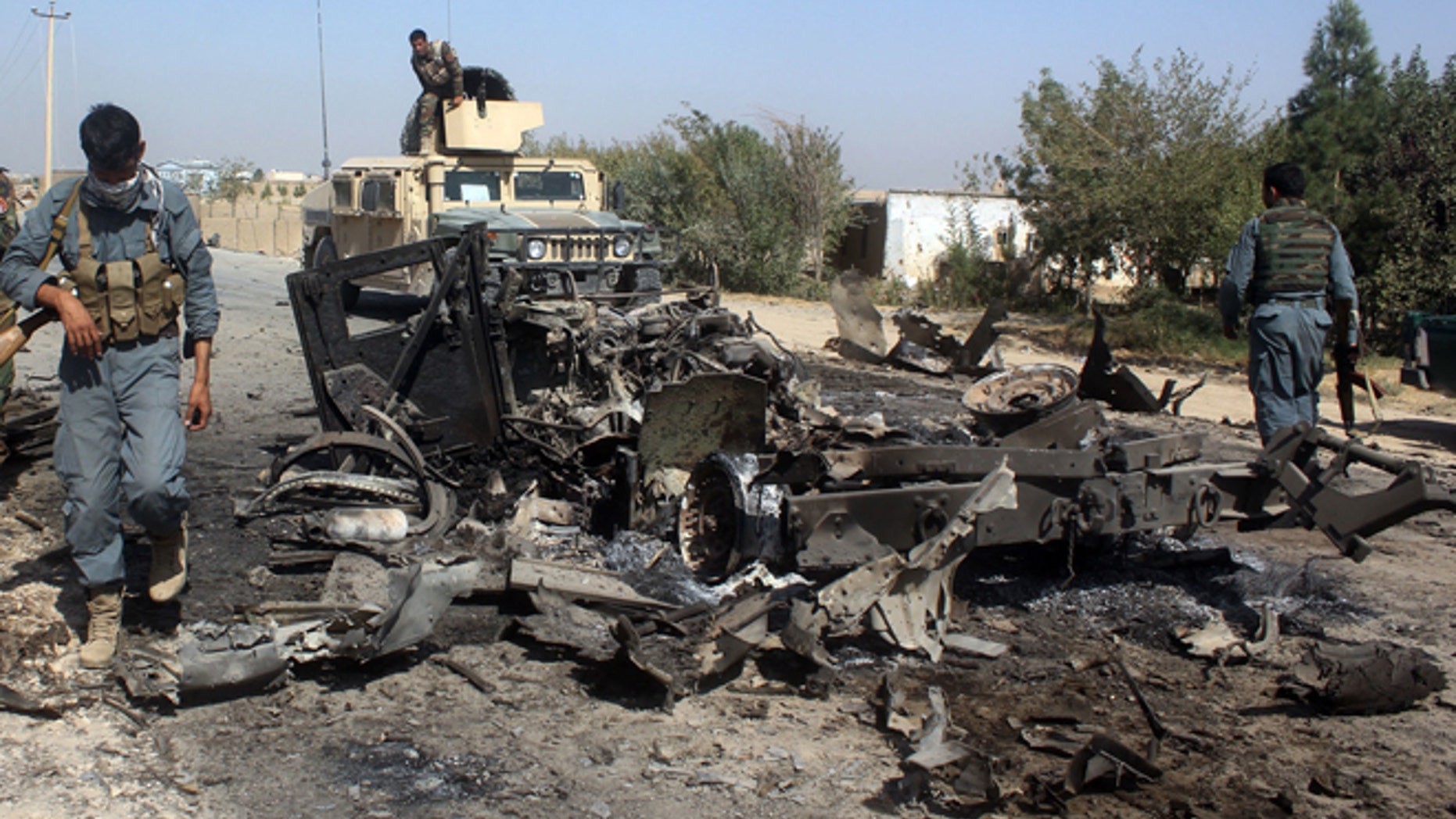 FILE: Afghan security forces inspect the site of a U.S. airstrike in Kunduz city.