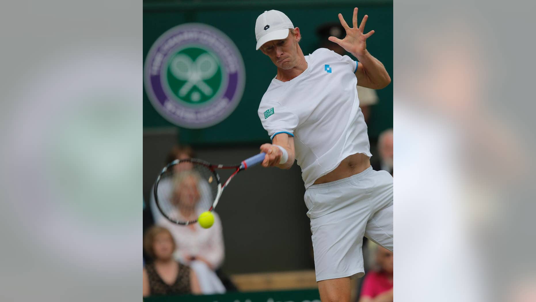 Kevin Anderson of South Africa plays a return to Andy Murray of Britain during their men's singles match at the All England Lawn Tennis Championships in Wimbledon, London, Monday, June 30, 2014. (AP Photo/Pavel Golovkin)