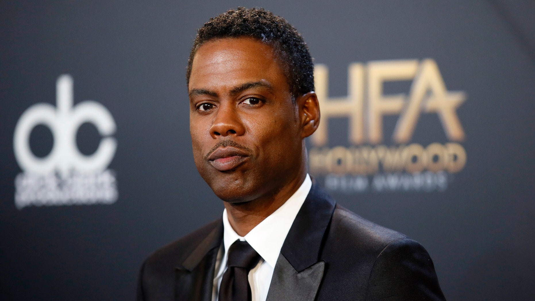 Actor Chris Rock poses backstage with his comedy film award for "Top Five" during the Hollywood Film Awards in Hollywood, California November 14, 2014. REUTERS/Danny Moloshok (UNITED STATES - Tags: ENTERTAINMENT) - RTR4E84B