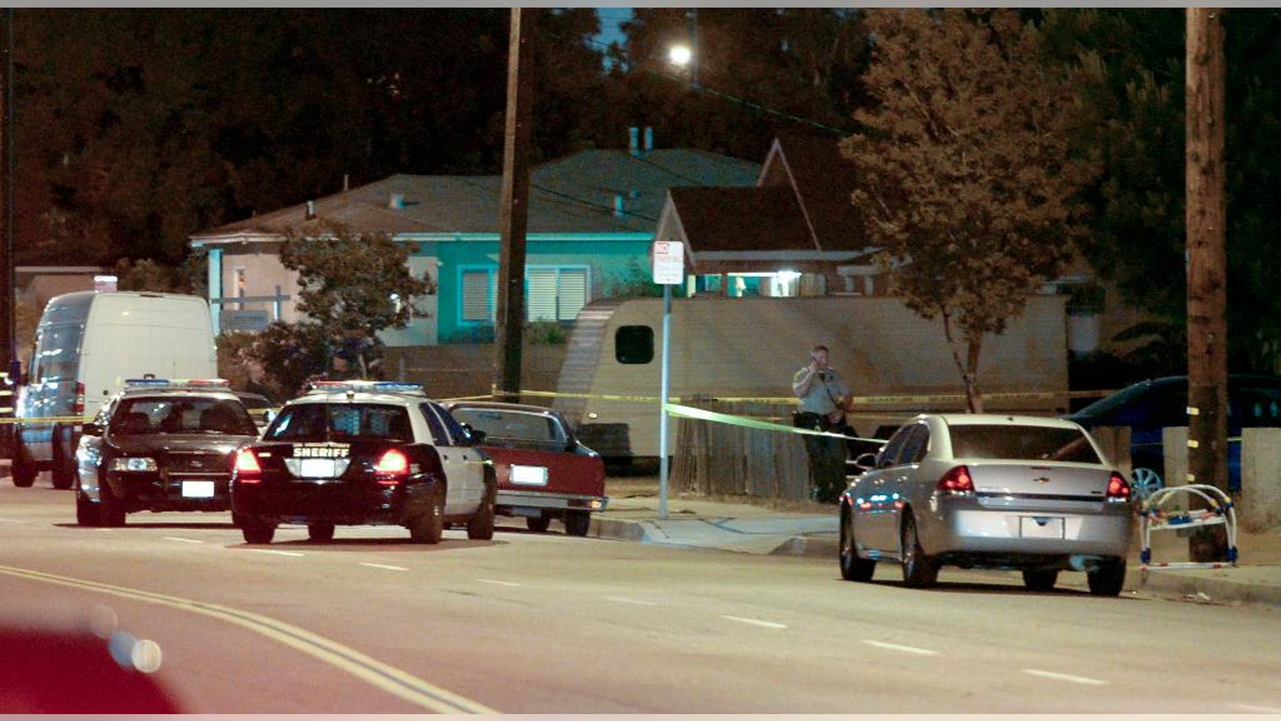Los Angeles County sheriff's deputies block off the scene of a triple homicide that occurred in the unincorporated area of Los Angeles, Calif., Tuesday, May 20, 2014. Carol Coronado, 30, was arrested on suspicion of murder, taken to a hospital for examination and then to a sheriff's station for booking. Authorities say she made no statement. (AP Photo/The Daily Breeze, Steve McCrank)