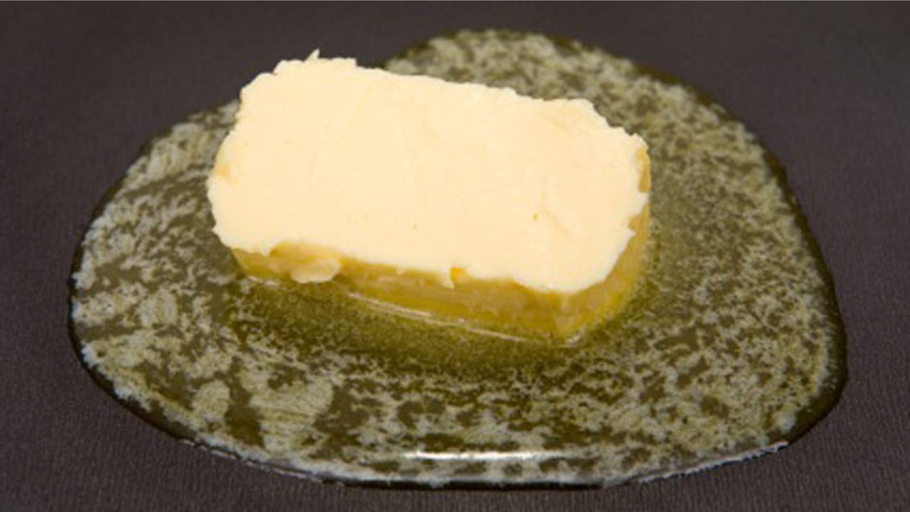Piece of butter melting on non-stick frying pan