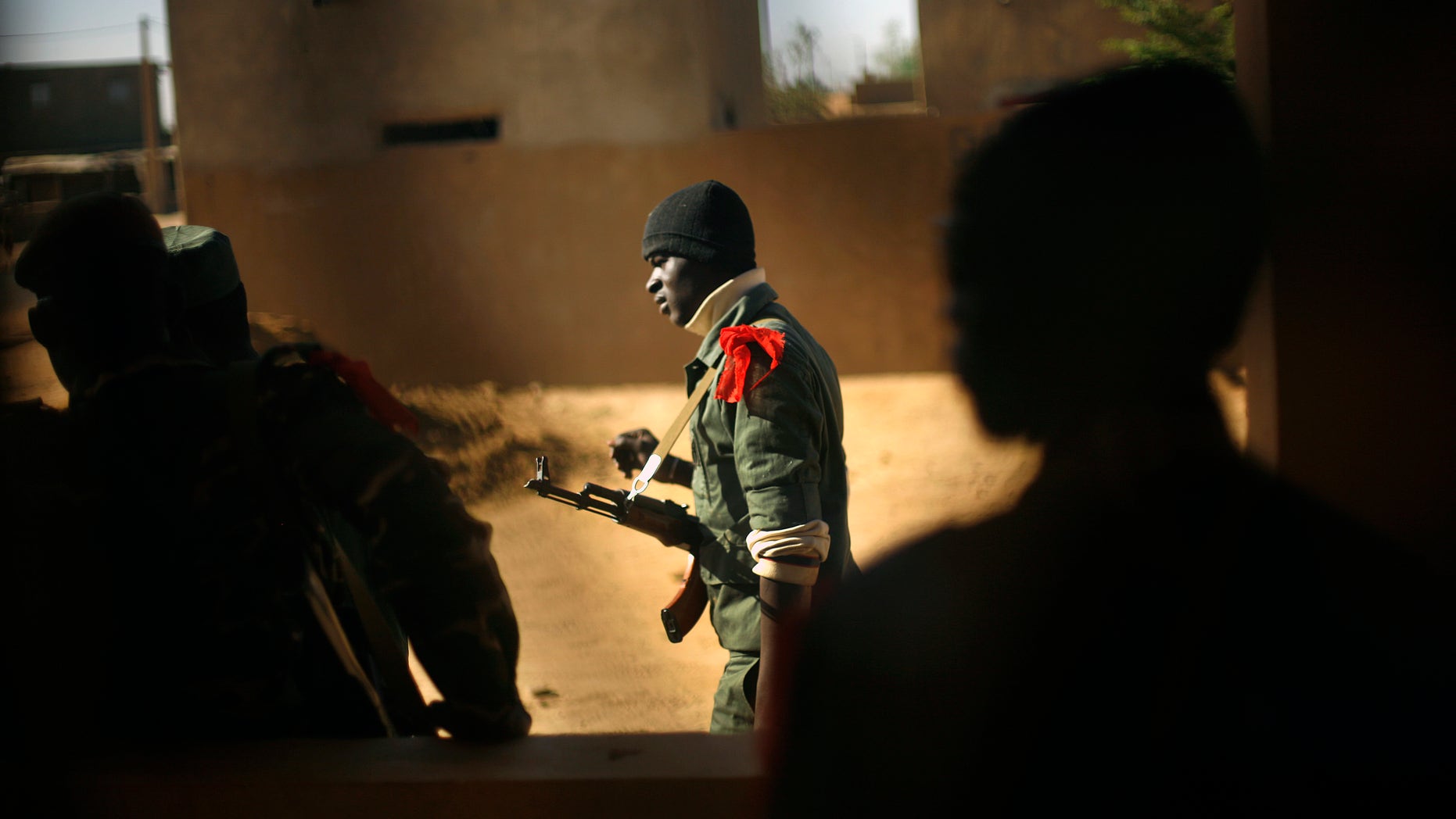 A Malian soldier walks in Gao, northern Mali, Thursday, Feb. 7, 2013. French troops began to withdraw from Timbuktu Thursday after securing the fabled city as they ramped up their mission in another northern Mali city, searching for Islamic extremists who may be mixing among the local population. (AP Photo/Jerome Delay)