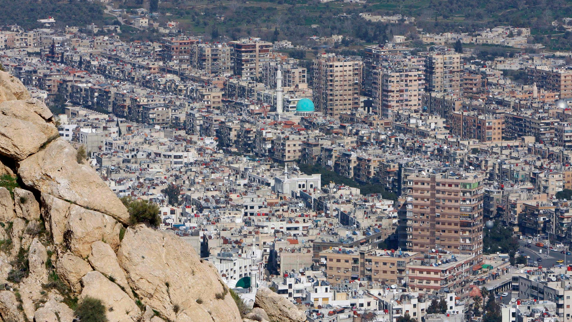 FILE - This Thursday, March 22, 2012 file photo shows a general view of Damascus, Syria. A barrage of rockets slammed into a contested district on the northeastern edge of Damascus, activists said Friday, April 5, 2013, killing at least five people and trapping others under the rubble, while violence raged around suburbs of the capital. (AP Photo/Muzaffar Salman, File)