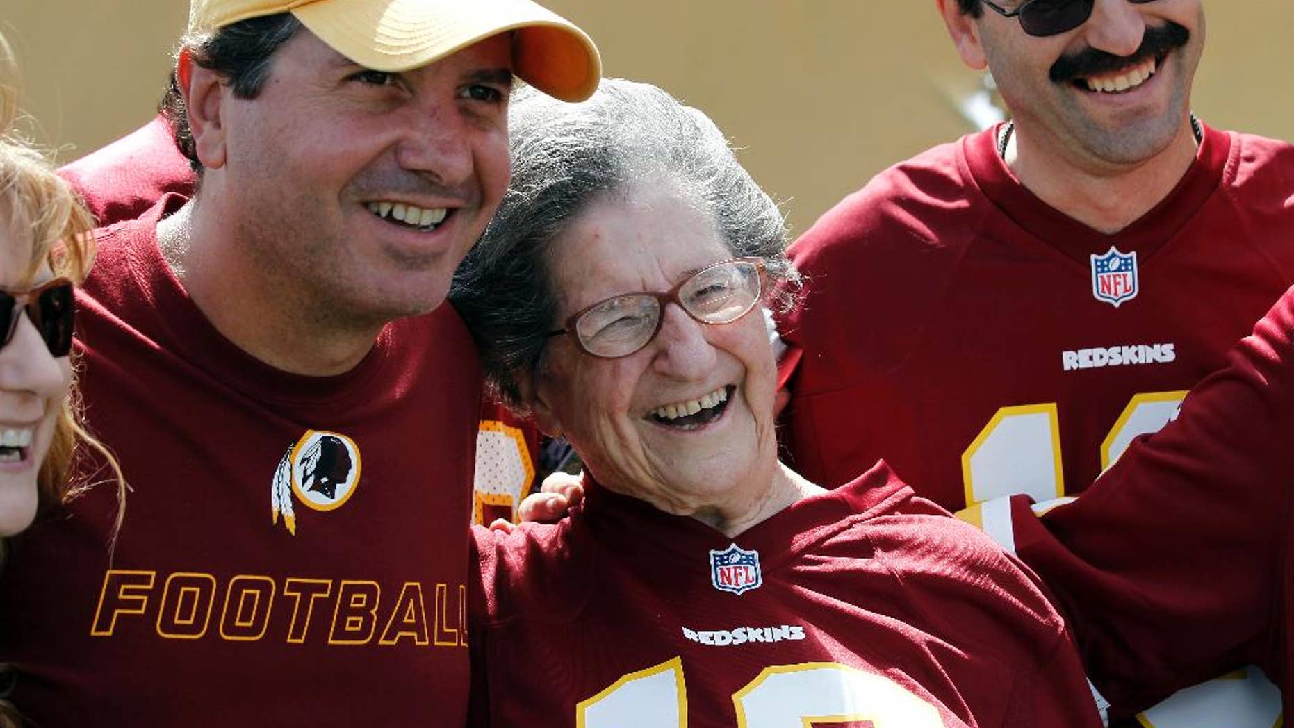 Washington Redskins owner Dan Snyder, left, poses for a photograph with Melba Jacobson, from Silver Spring, Md., who is celebrating her upcoming 90th birthday, after practice at the team's NFL football training facility, Monday, July 28, 2014 in Richmond, Va. (AP Photo/Alex Brandon)