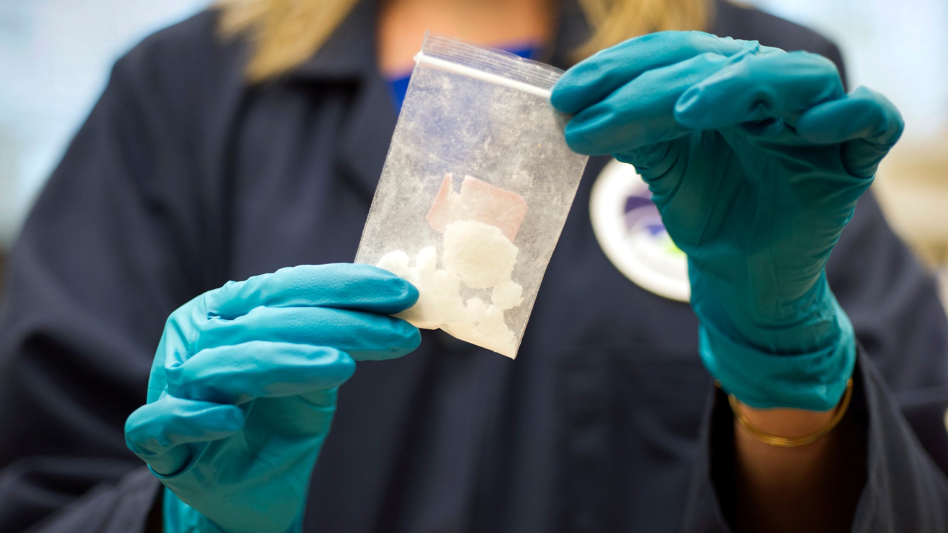 FILE -- In this Aug. 9, 2016, photo, a bag of 4-fluoroisobutyrylfentanyl, which was seized in a drug raid, is displayed at the Drug Enforcement Administration (DEA) Special Testing and Research Laboratory in Sterling, Va.