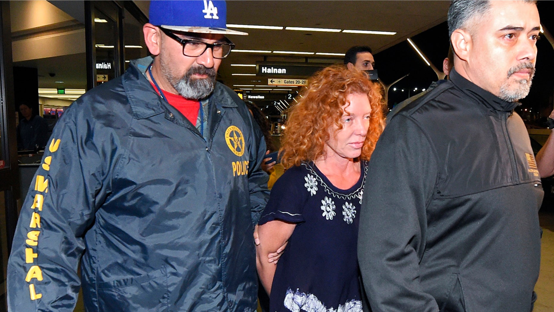 Dec. 31, 2015: Tonya Couch, center, is taken by authorities to a waiting car after arriving at Los Angeles International Airport (AP Photo/Mark J. Terrill)