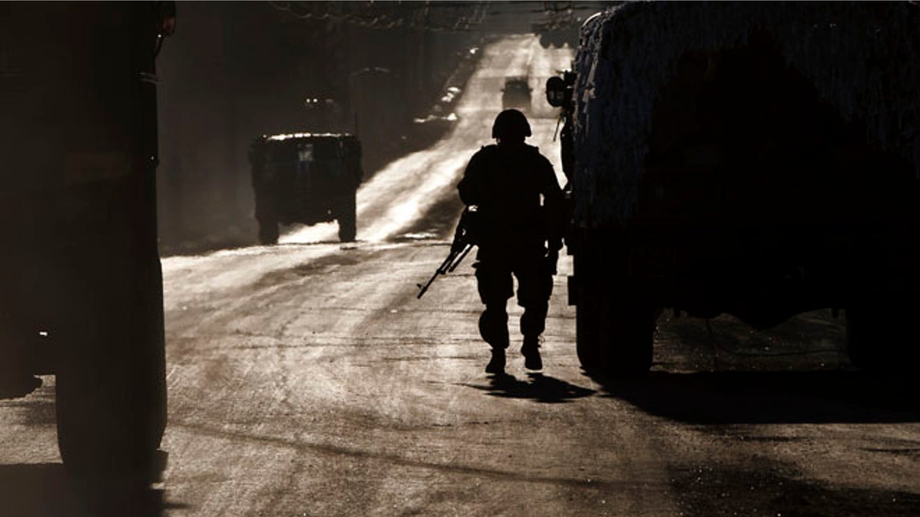 Feb. 18, 2015: An Ukrainian soldier stands next to a broken down vehicle outside Artemivsk, Ukraine, as troops pull out of Debaltseve,