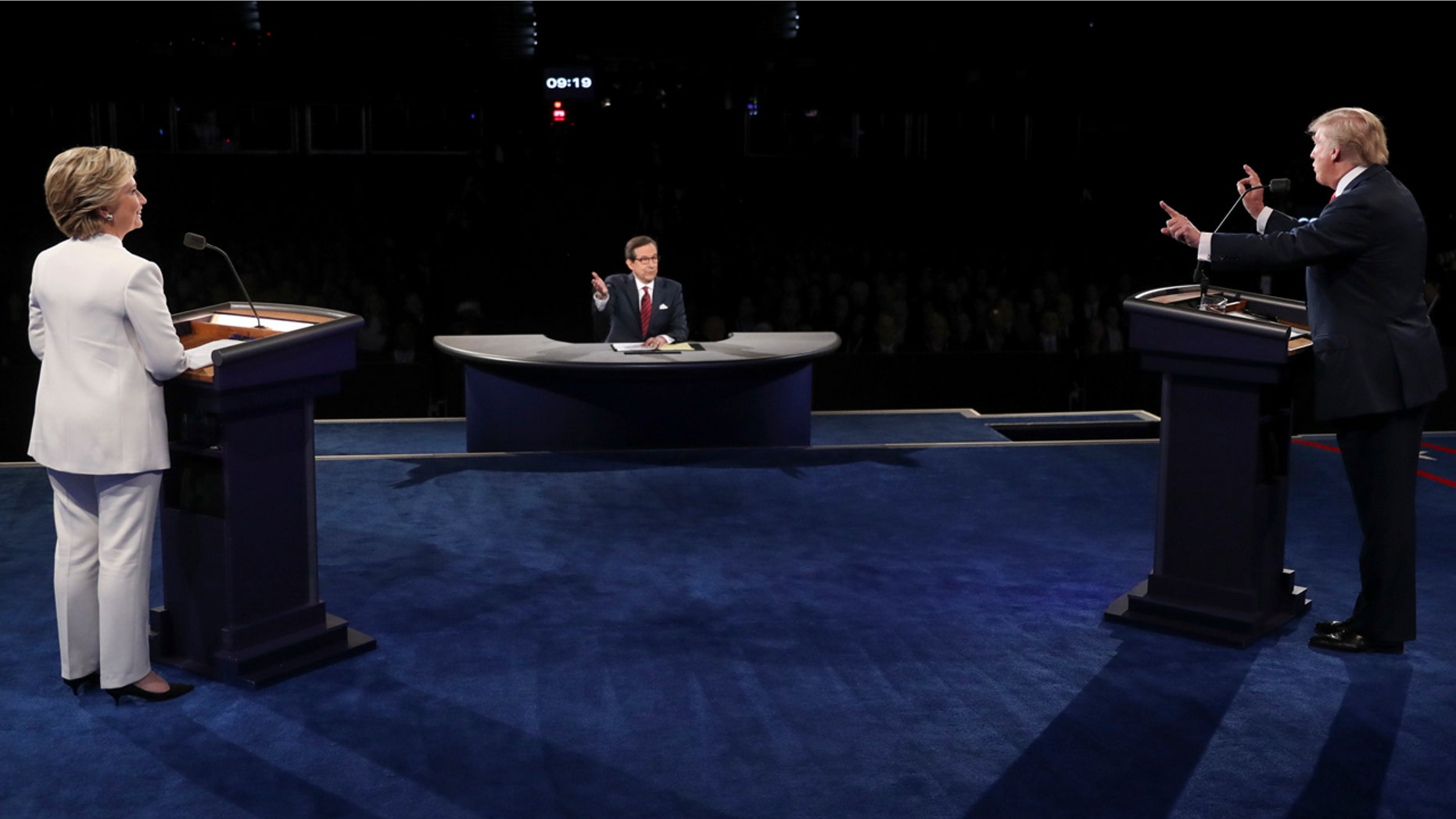 Democratic presidential nominee Hillary Clinton listens as Republican presidential nominee Donald Trump answers a question during the third presidential debate at UNLV in Las Vegas, Wednesday, Oct. 19, 2016. (Joe Raedle/Pool via AP)