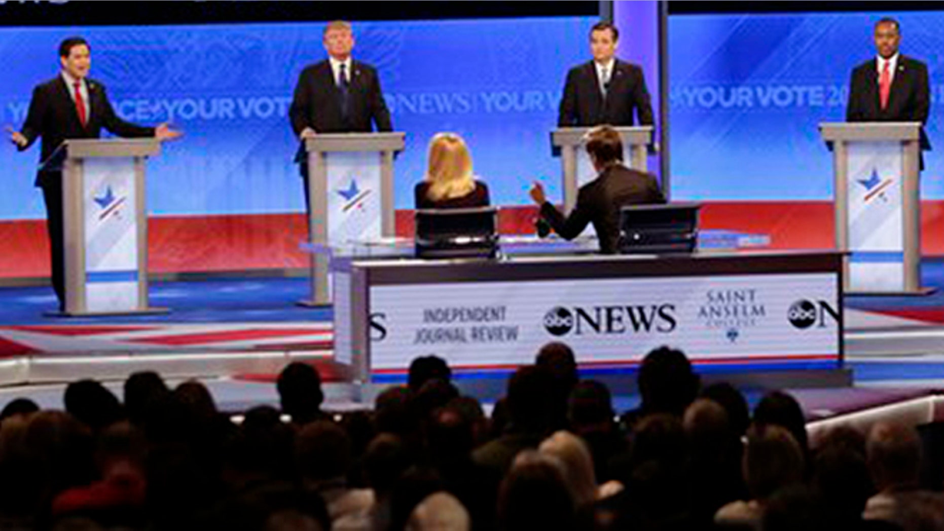 Republican presidential candidate, Sen. Marco Rubio, R-Fla., left, spars with Republican presidential candidate, New Jersey Gov. Chris Christie, right as Republican presidential candidate, businessman Donald Trump, Republican presidential candidate, Sen. Ted Cruz, R-Texas, and Republican presidential candidate, retired neurosurgeon Ben Carson listen during a Republican presidential primary debate hosted by ABC News at the St. Anselm College Saturday, Feb. 6, 2016, in Manchester, N.H. (AP Photo/David Goldman)