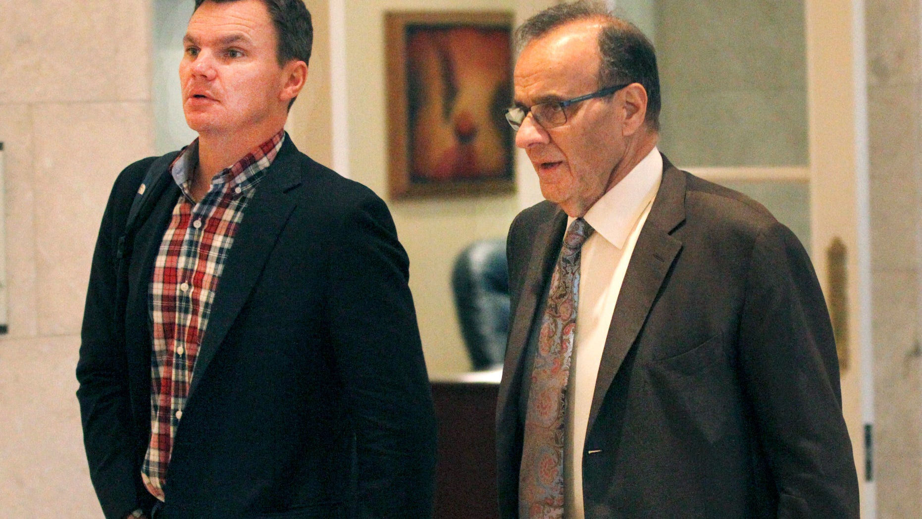 Major League Baseball executive Joe Torre, right, and Boston Red Sox general manager Ben Cherington talk in the hallway at the annual general managers meeting Tuesday, Nov. 12, 2013, in Orlando, Fla. (AP Photo/Reinhold Matay)