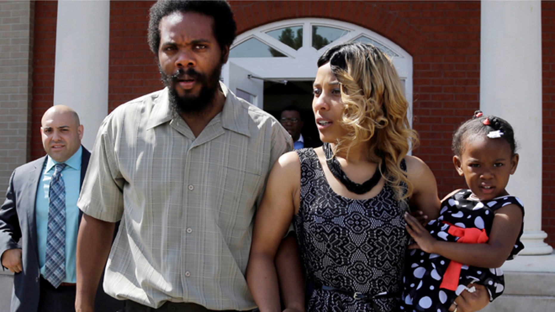 March 5, 2014: Cornealious "Mike" Anderson walks out of the Mississippi County Courthouse along with his wife, LaQonna Anderson, daughter Nevaeh, 3, and attorney Patrick Megaro, far left, after being released from custody in Charleston, Mo.