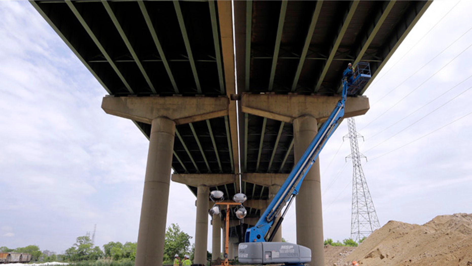 June 3, 2014: A worker inspects the underside of the Interstate 495 bridge over the Christina River near Wilmington, Del., after it was closed due to the discovery of tilting support columns.