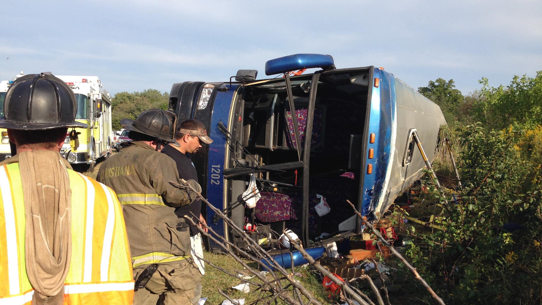 Sept. 21, 2014: Passengers from a tour bus are treated for injuries near the overturned bus at the Tybouts Corner on ramp from southbound Del. 1 to Red Lion Road.