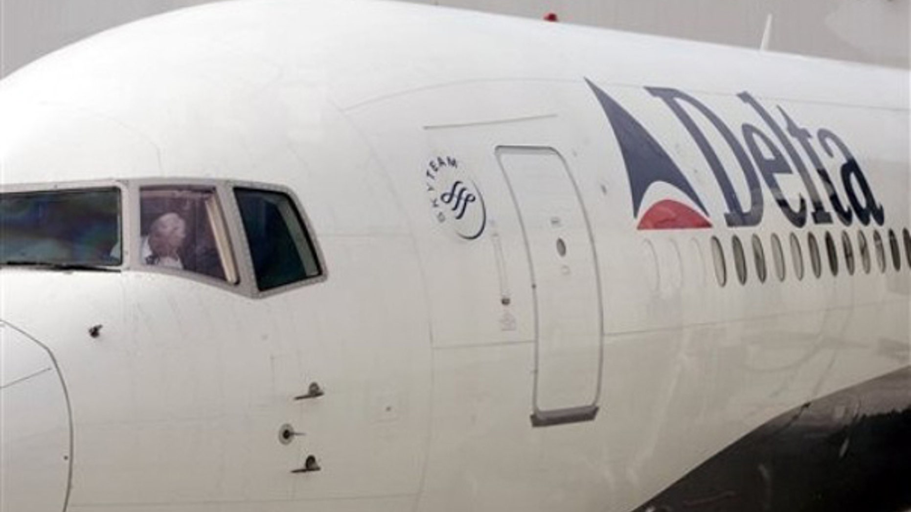 In this June 2, 2005 file photo, a Delta Airlines pilot sits in the cockpit after parking at the Seattle airport. (AP Photo)
