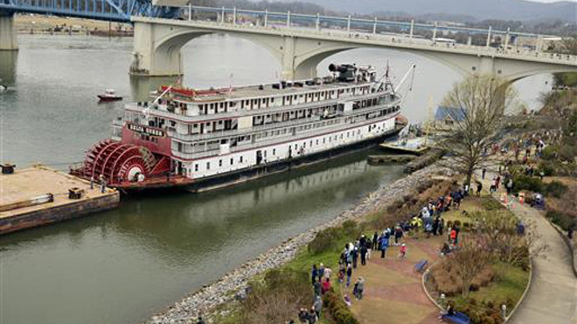 In this March 22, 2015 file photo, spectators line the bank of the Tennessee River as the Delta Queen riverboat waits to depart from Chattanooga, Tenn., on its way to Louisiana for restoration.