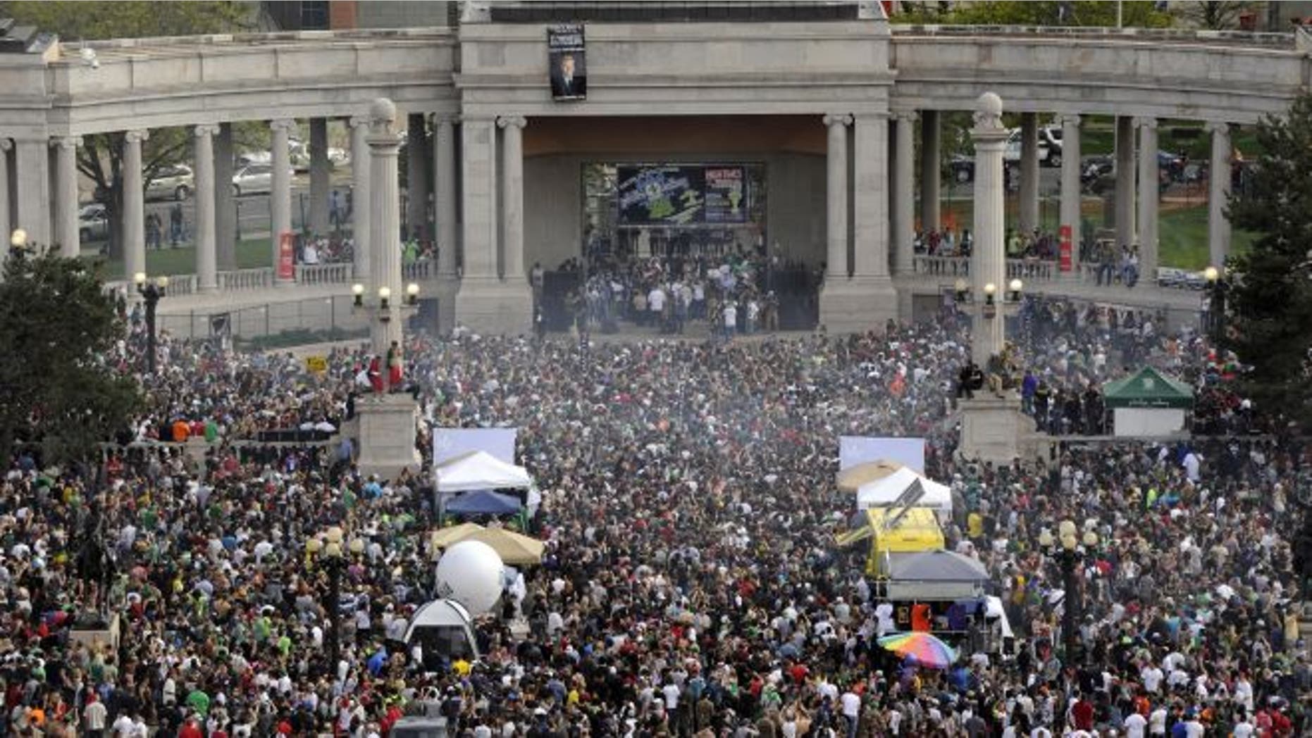 FILE: This April 20, 2012 file photo shows a cloud of smoke covering the crowd at the Denver 420 rally in Civic Center Park.