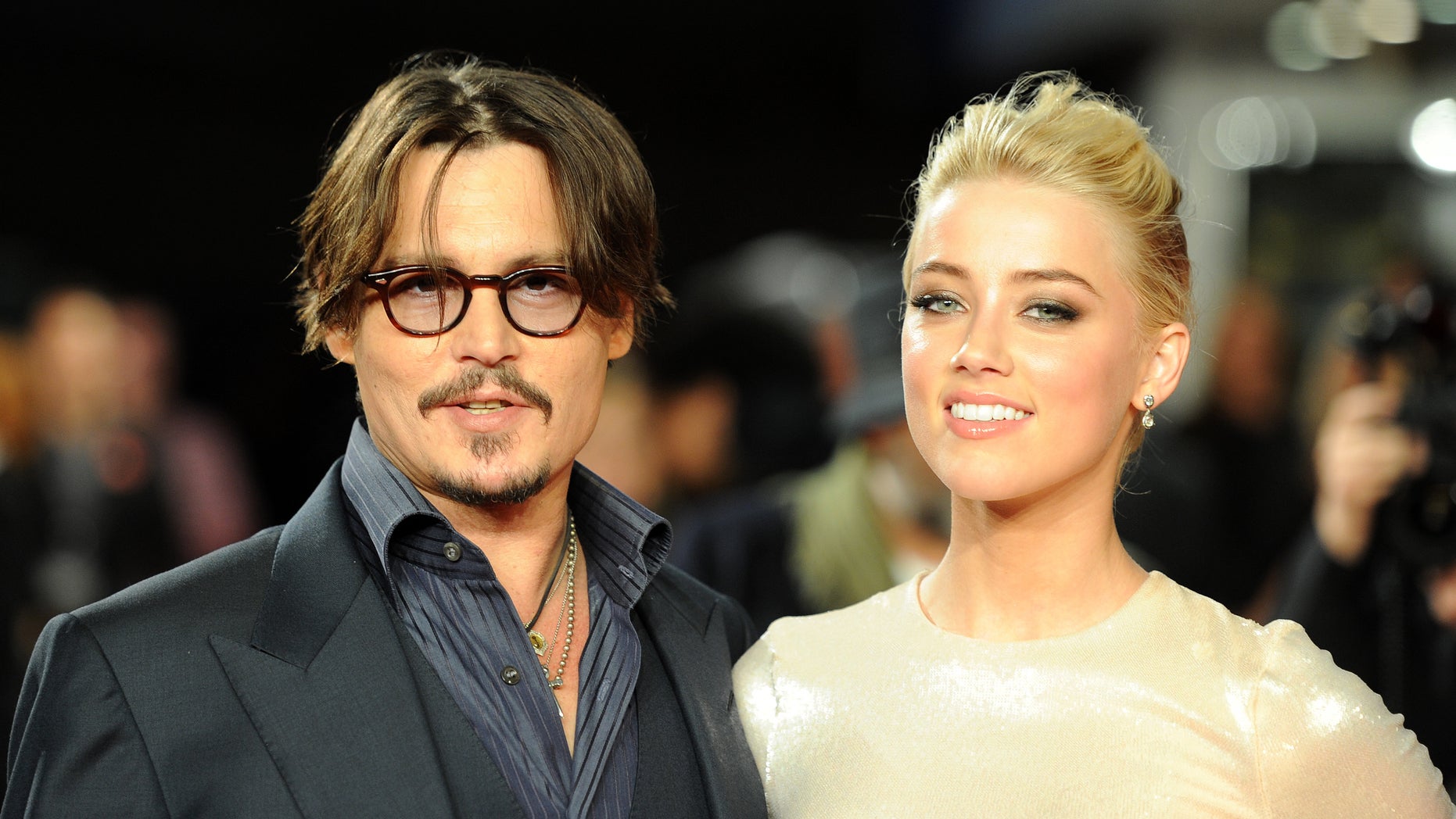 November 3, 2011. Johnny Depp and Amber Heard pose for photographers as they arrive for the European premiere of "The Rum Diary" in London.