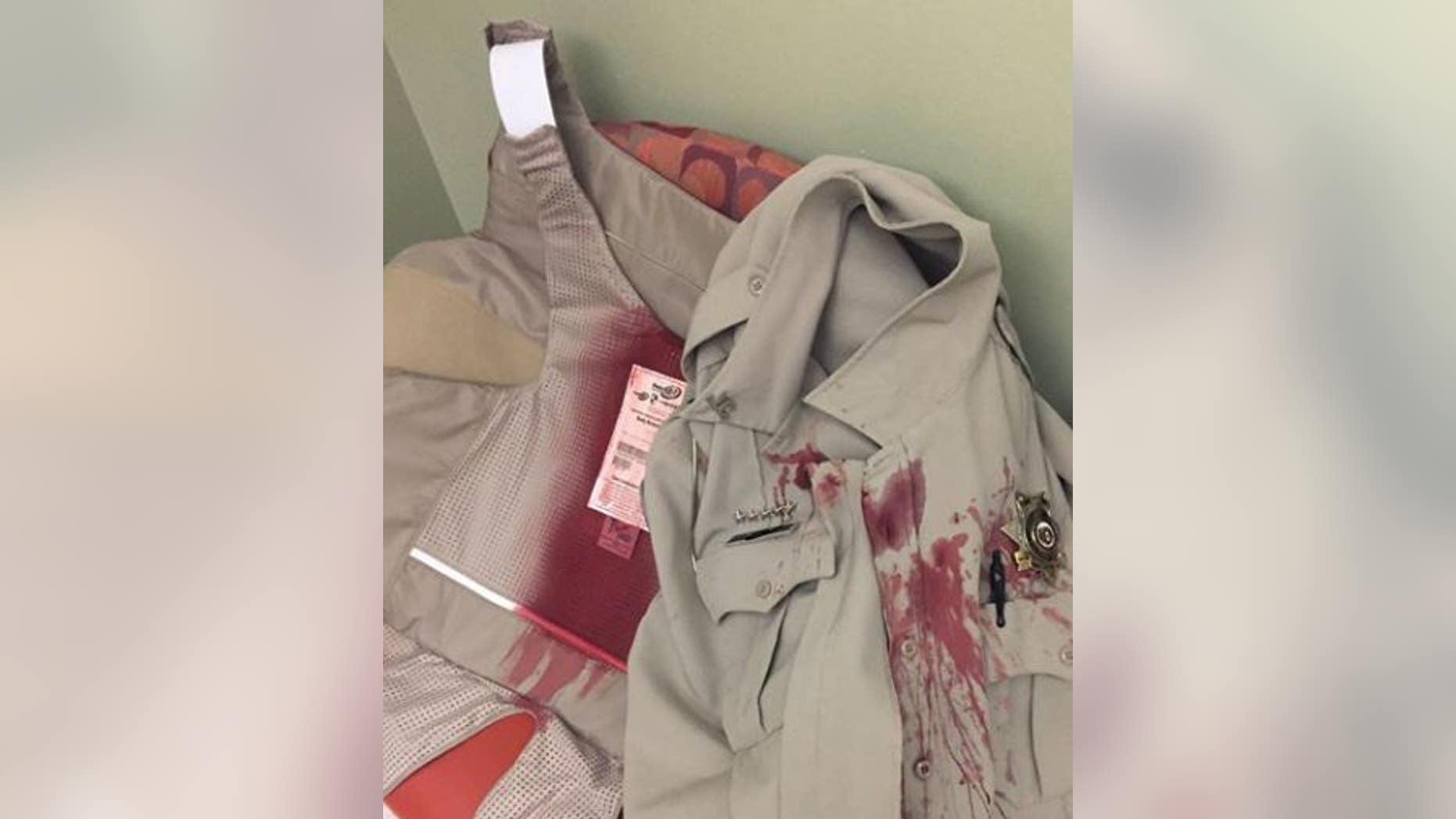 The image shows a Missouri police officer's bload-soaked uniform after he was attacked by a dog while serving a civil summons on Tuesday.