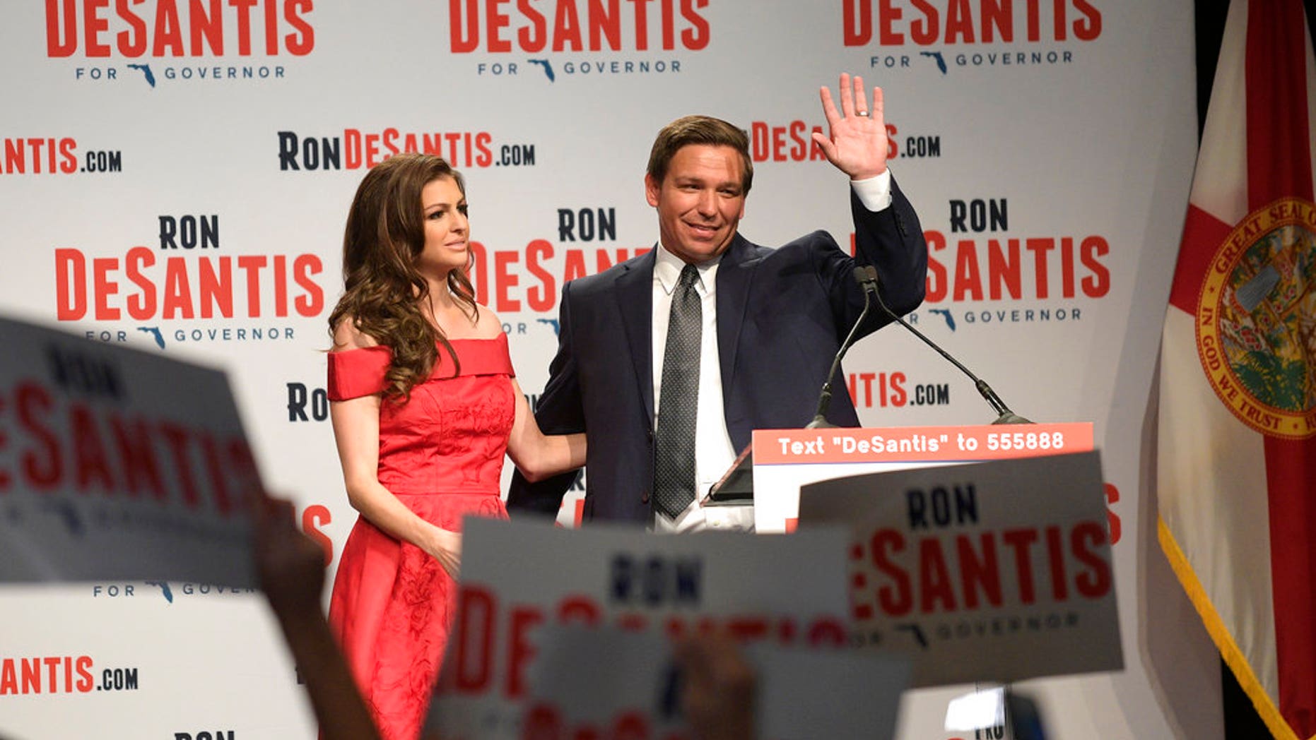 Florida Republican gubernatorial candidate Ron DeSantis, right, waves to supporters with his wife, Casey, at an election party after winning the Republican primary, Tuesday, Aug. 28, 2018, in Orlando, Fla. (AP Photo/Phelan M. Ebenhack)