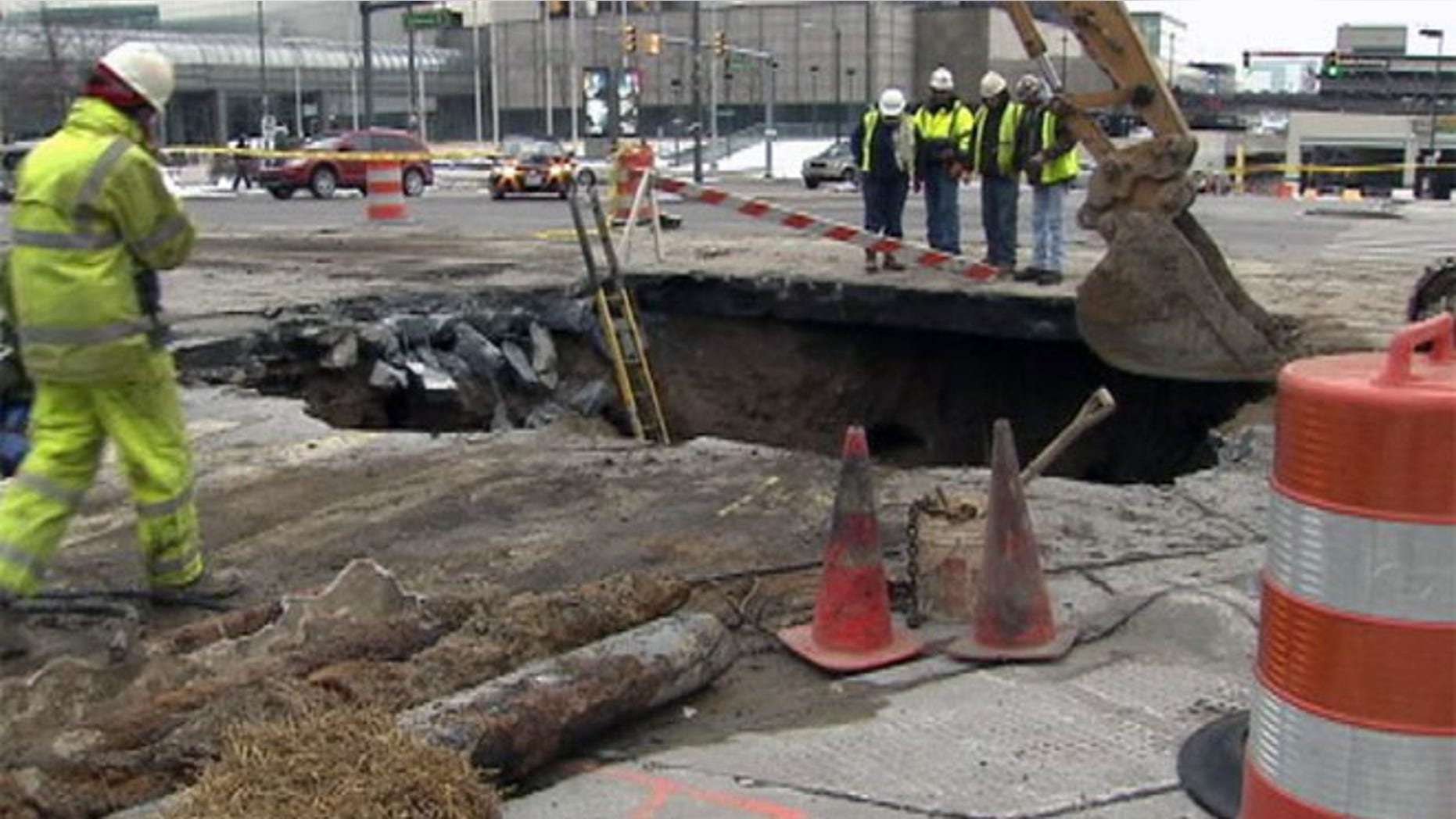 Crews are picture working on a sinkhole that has opened up in Detroit.