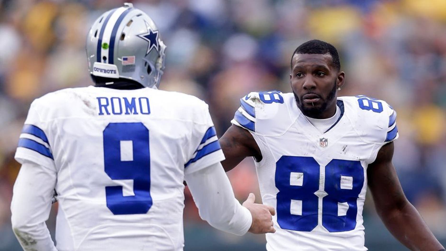 GREEN BAY, WI - JANUARY 11: Tony Romo #9 and Dez Bryant #88 of the Dallas Cowboys wait for an officials' review during the 2015 NFC Divisional Playoff game at Lambeau Field on January 11, 2015 in Green Bay, Wisconsin. (Photo by Mike McGinnis/Getty Images)
