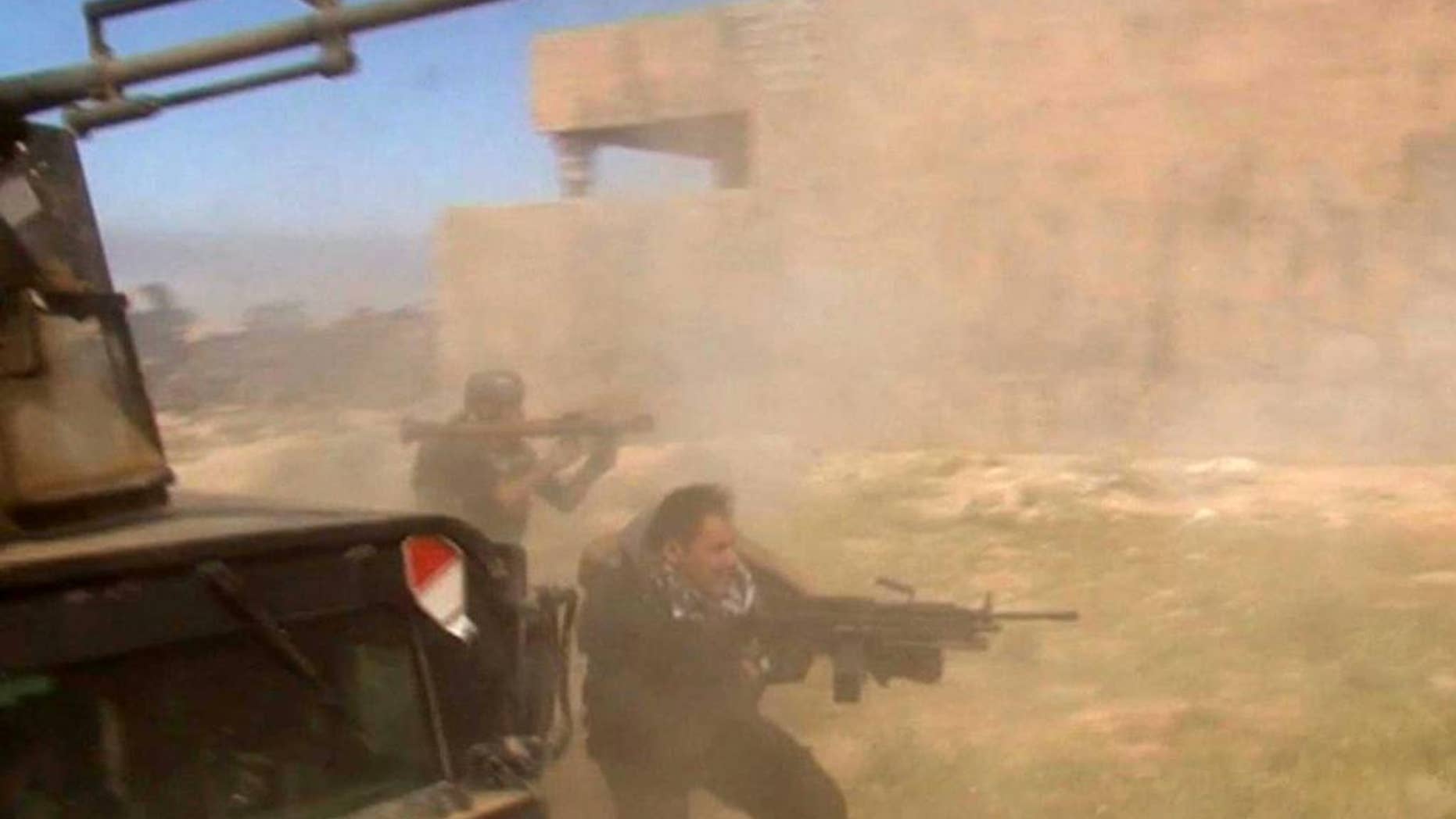 March 11, 2015: In this still image taken from video, soldiers fire towards a target in Tikrit, Iraq on Wednesday. (AP)