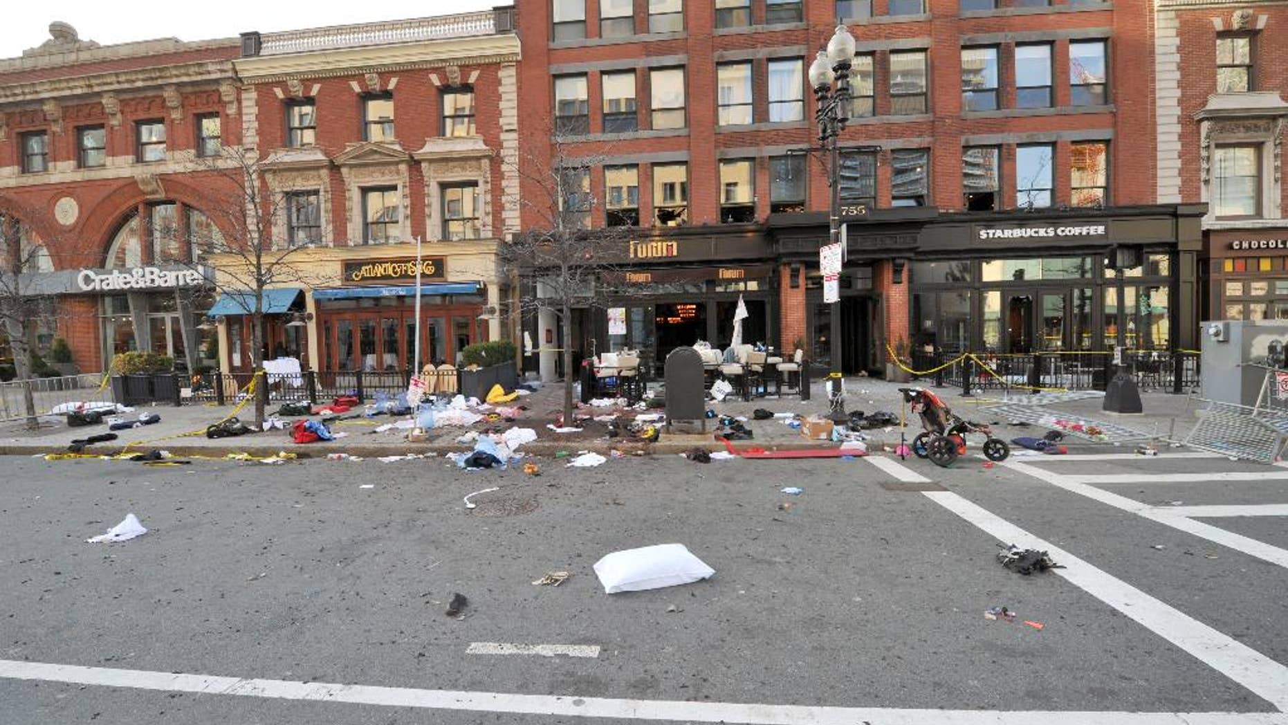 This April 15, 2013 forensics photograph made by the FBI, and provided Thursday, April 23, 2015, by the U.S. Attorney's office, and presented in federal court as evidence during the penalty phase of convicted Boston Marathon bomber Dzhokhar Tsarnaev's trial, shows the scene where the second bomb exploded on Boylston Street near the marathon finish line in Boston. Three people were killed and more than 260 others were wounded when twin bombs exploded. The prosecution rested its case Thursday during the penalty phase of Boston Marathon bomber Dzhokhar Tsarnaev's trial after playing a video showing a mother crouched over her 8-year-old son and resting her head on his chest as he lay dying. (U.S. Attorney's Office via AP)