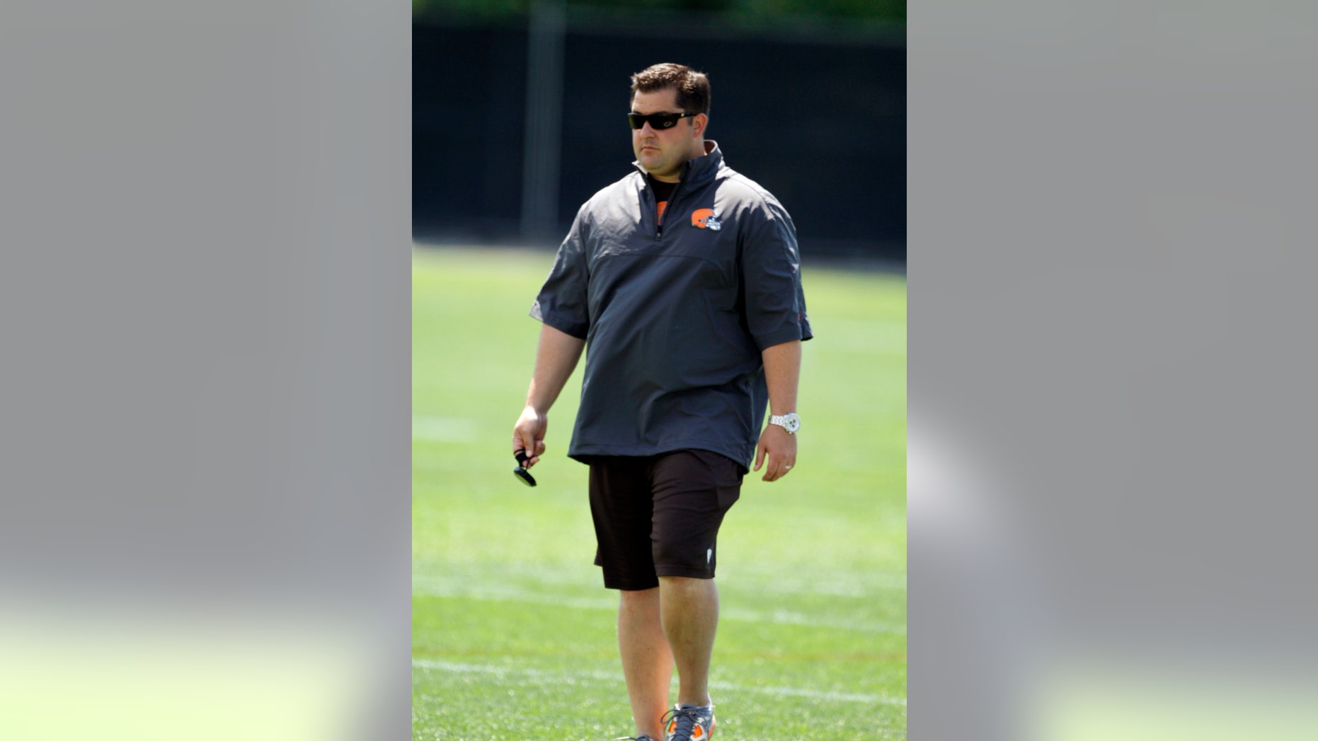In this June 7, 2012 photo, Cleveland Browns director of player personnel Jon Sandusky watches an off-season practice at the NFL football team's headquarters in Berea, Ohio. Jon Sandusky, the son of former Penn State assistant coach Jerry Sandusky, was arrested early Tuesday morning, Oct. 8, 2013, on suspicion of drunken driving. Fargo, N.D. police Lt. Joel Vettel told The Forum of Fargo-Moorhead that an officer spotted Jon Sandusky, 36, making an illegal turn. The officer pulled Sandusky over and decided he was driving under the influence after administering field sobriety tests. (AP Photo/Mark Duncan)