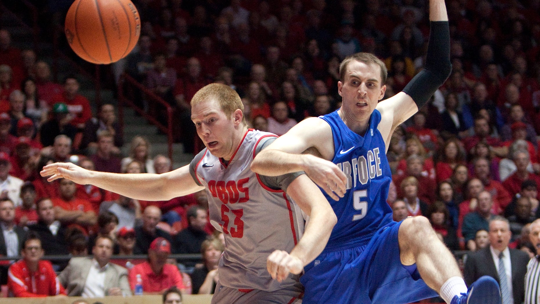 New Mexico's Alex Kirk, left, battles Air Force's Mike Fitzgerald for a loose ball in the first half of their NCAA college basketball game in Albuquerque, N.M., Wednesday, Feb. 6, 2013. (AP Photo/ Eric Draper)