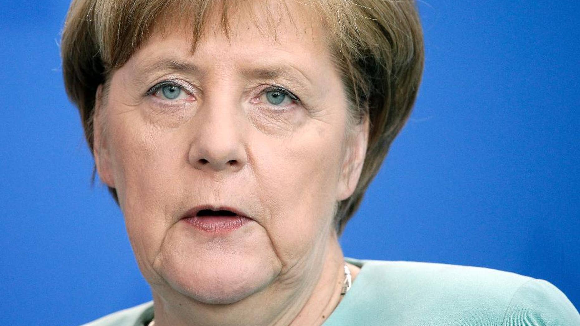 German Chancellor Angela Merkel addresses the media during a joint news conference with the President of Azerbaijan, Ilham Aliyev, as part of a meeting at the chancellery in Berlin, Germany, Tuesday, June 7, 2016. (AP Photo/Michael Sohn)