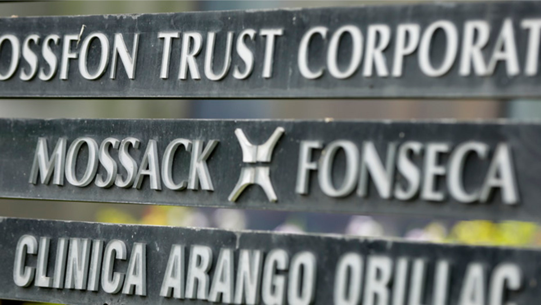 FILE - In this April 4, 2016 file photo, a marquee on a building in Panama City, Panama, lists the Mossack Fonseca law firm, one of the leaders in setting up offshore bank accounts for the rich and powerful. Offshore accounts conjure up images of malicious misdeeds, but many people use them for more than just hiding bribes and laundering money. And offshore accounts can be a financial tool for more than just the ultra-wealthy, too. (AP Photo/Arnulfo Franco, File)