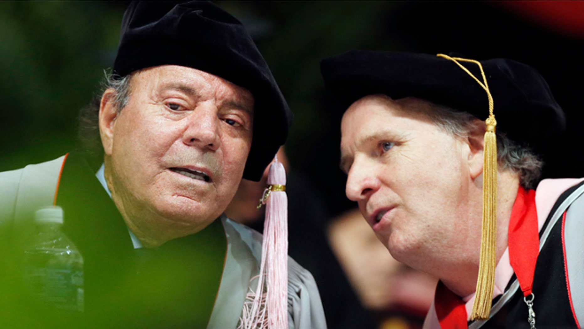 Julio Iglesias, left, speaks with Berklee College of Music president Roger Brown before receiving an honorary doctor of music degree during commencement ceremonies, Saturday, May 9, 2015, in Boston. (AP Photo/Michael Dwyer)