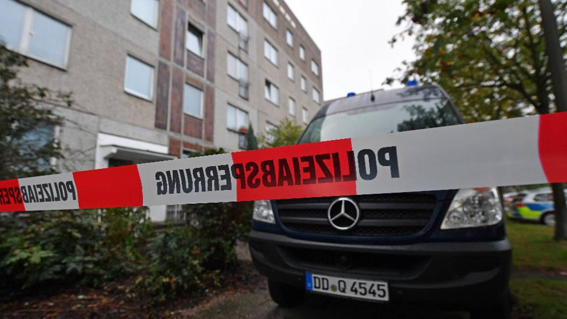 Oct. 10, 2016: A police barrier tape and a vehicle of a forensic team blocks off the entrance to an apartment in the Paunsdorf district of Leipzig, Germany.