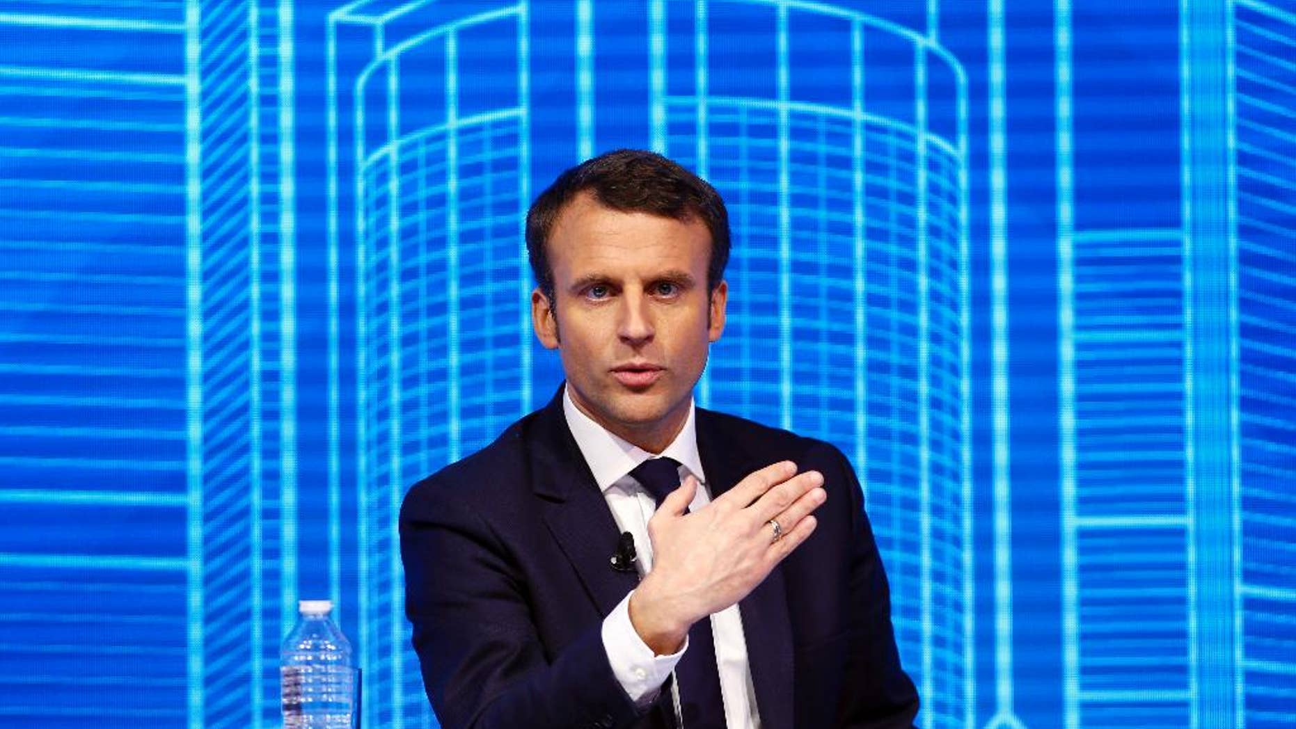 Emmanuel Macron, candidate for the 2017 French presidential elections of the "En Marche" movement participates to the Construction Forum debate "reinvest France" ("Reinvestissons la France") at Carrousel du Louvre in Paris, Thursday, Feb. 23, 2017. (AP Photo/Francois Mori)