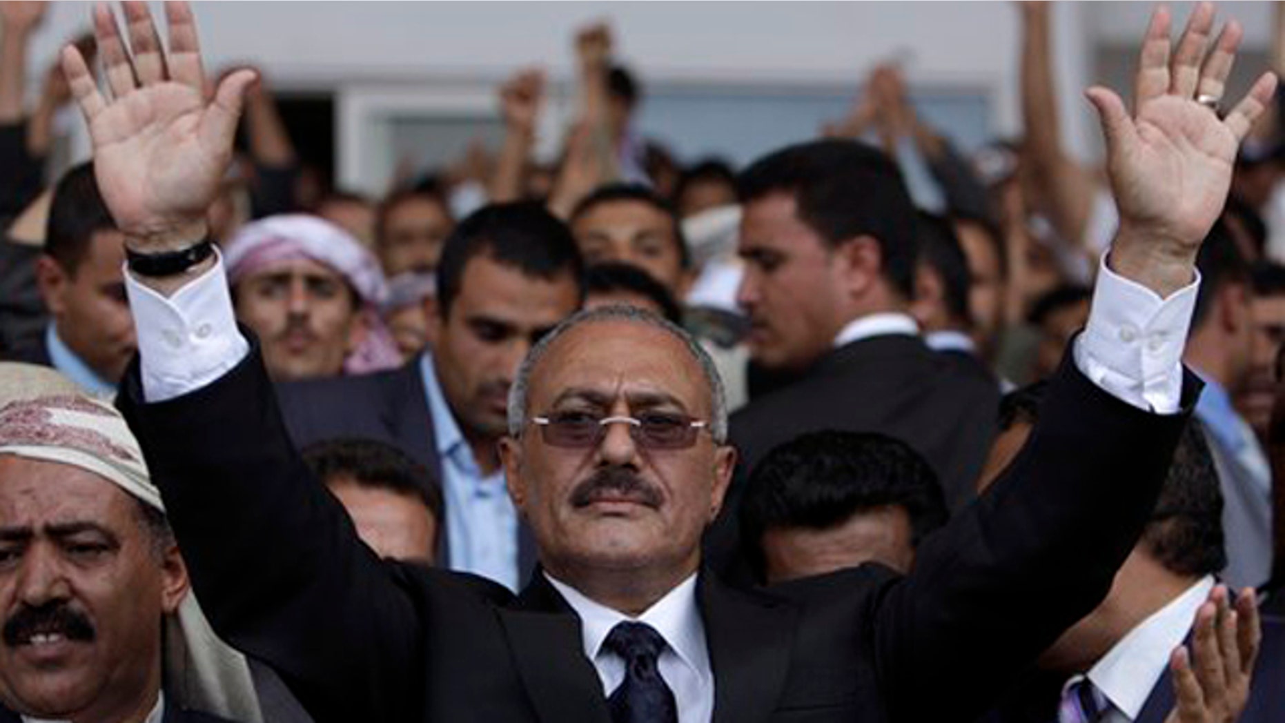 FILE - In this April 15, 2011 file photo, Yemeni President Ali Abdullah Saleh waves to his supporters, not pictured, during a rally in Sanaa,Yemen.