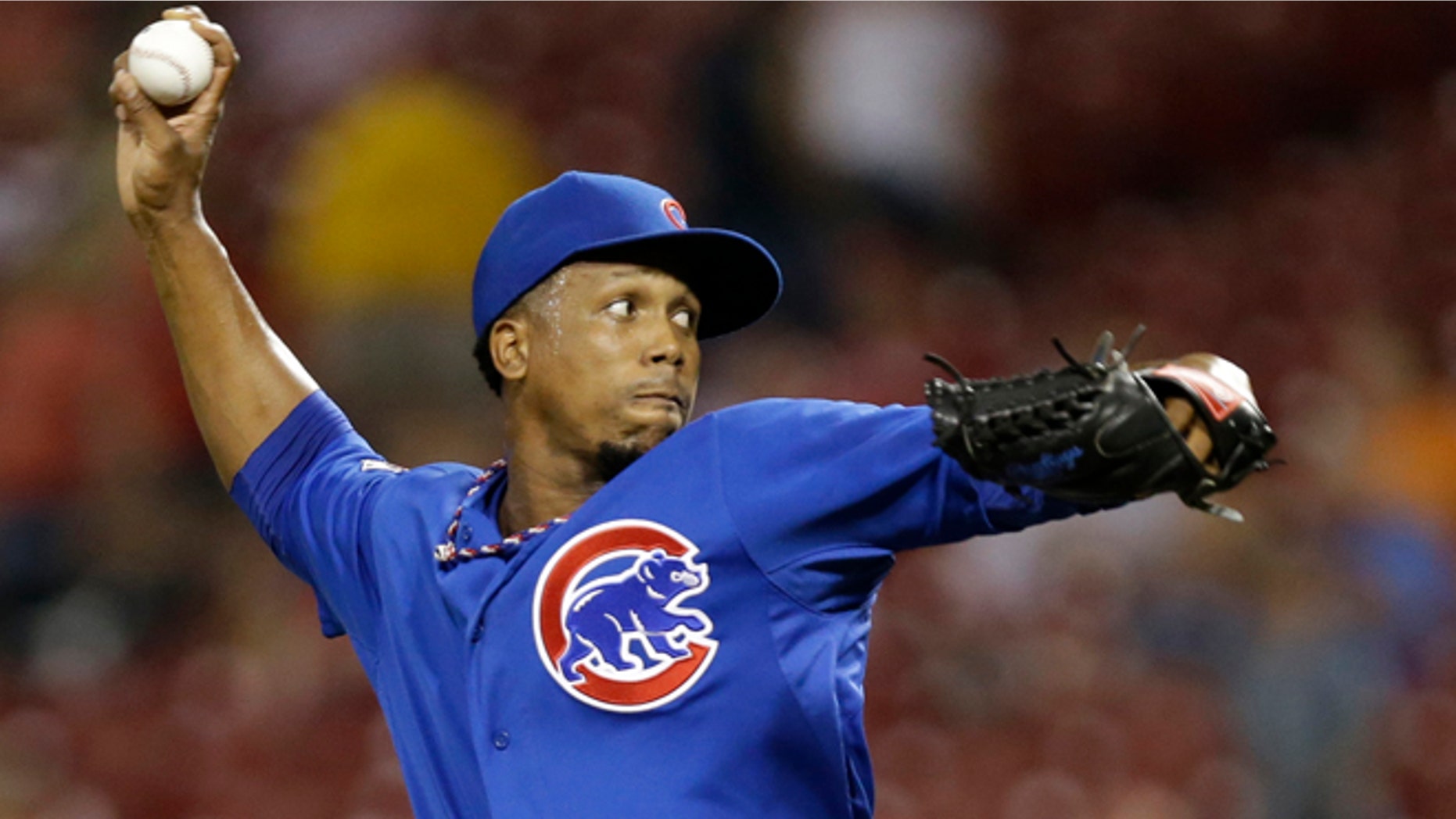 In this Aug. 26, 2014, file photo, Chicago Cubs relief pitcher Pedro Strop throws against the Cincinnati Reds during the eighth inning of a baseball game in Cincinnati. Strop was involved in a car accident in his native Dominican Republic but was not injured, officials said Friday, Nov. 28, 2014. The 29-year-old was driving a pickup truck when he crashed against a wall late Wednesday along a road southwest of the capital of Santo Domingo. (AP Photo/Al Behrman, File)