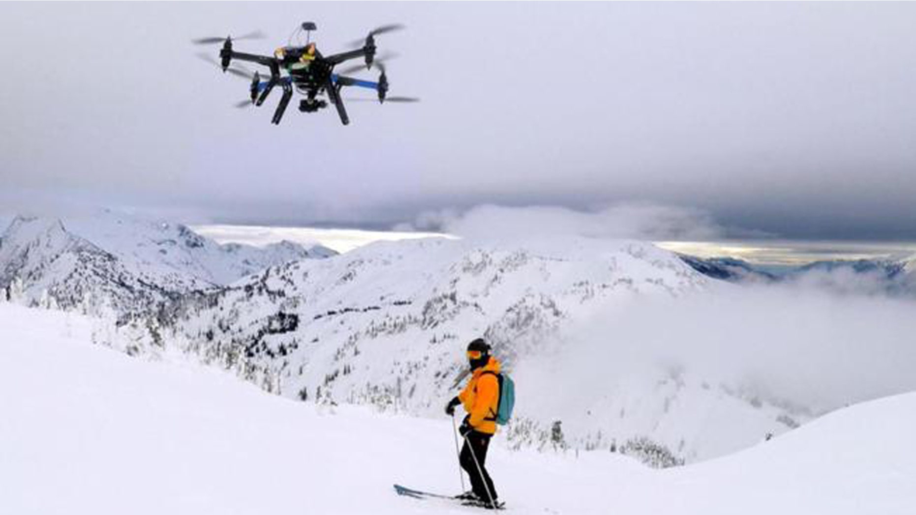 A drone camera hovering by a skier as he makes his way down mountainside at resort at Revelstoke, B.C., Canada in Dec. 2014.