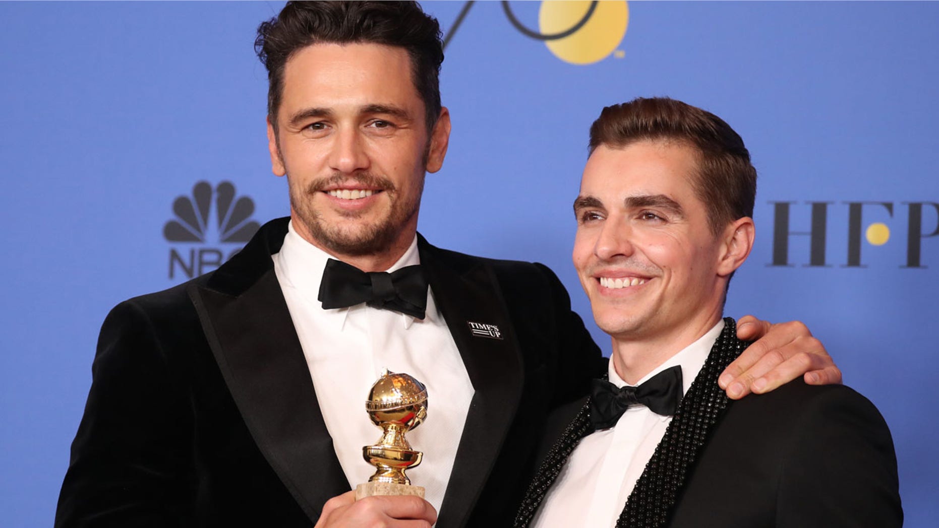 From the left, James Franco poses with his brother Dave Franco after winning a Golden Globe for "The Disaster Artist."