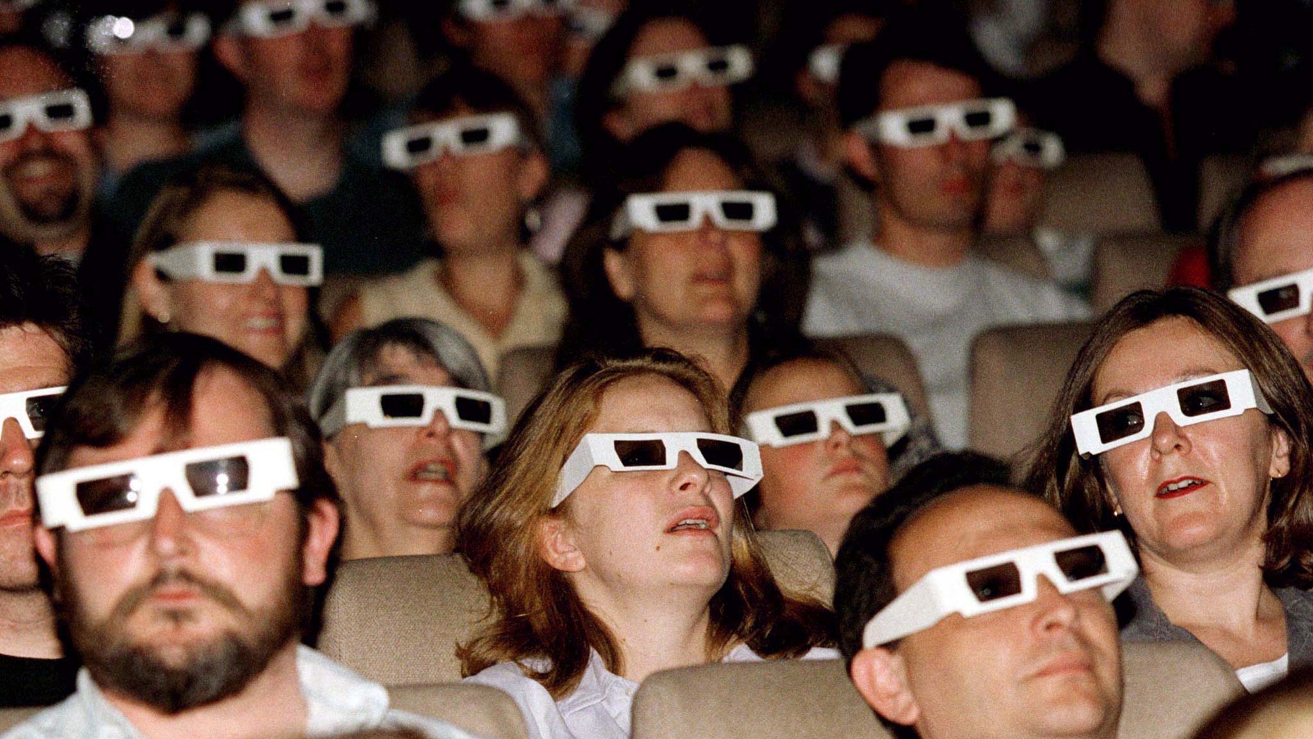 File photo - An audience watches a film through 3D spectacles at the launch screening of The National Film Theatre 3D film season, August 8, 1996. (Reuters)