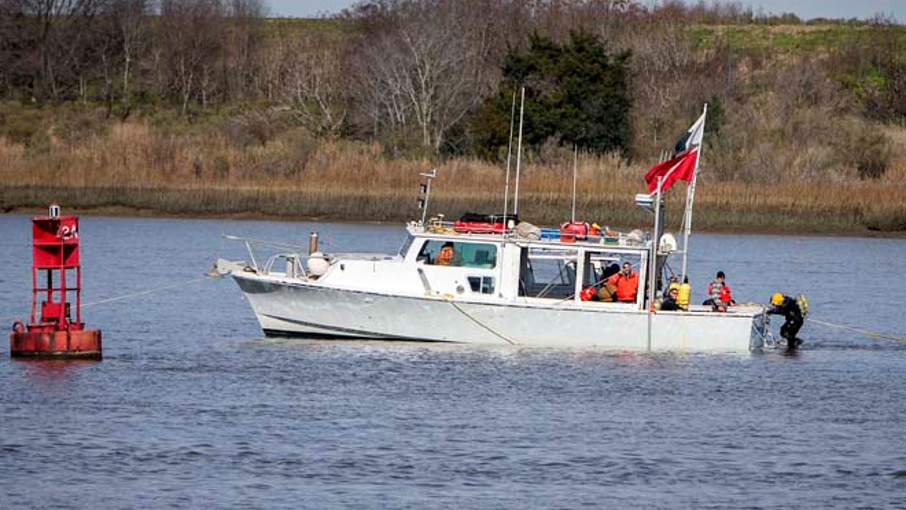 FILE 2015: Divers prepare to descend onto the wreck site of the CSS Georgia near the channel of the Savannah River, Savannah, Ga. The recovery of the Confederate ironclad ship marks the beginning of the construction phase of the Savannah Harbor Expansion Project.