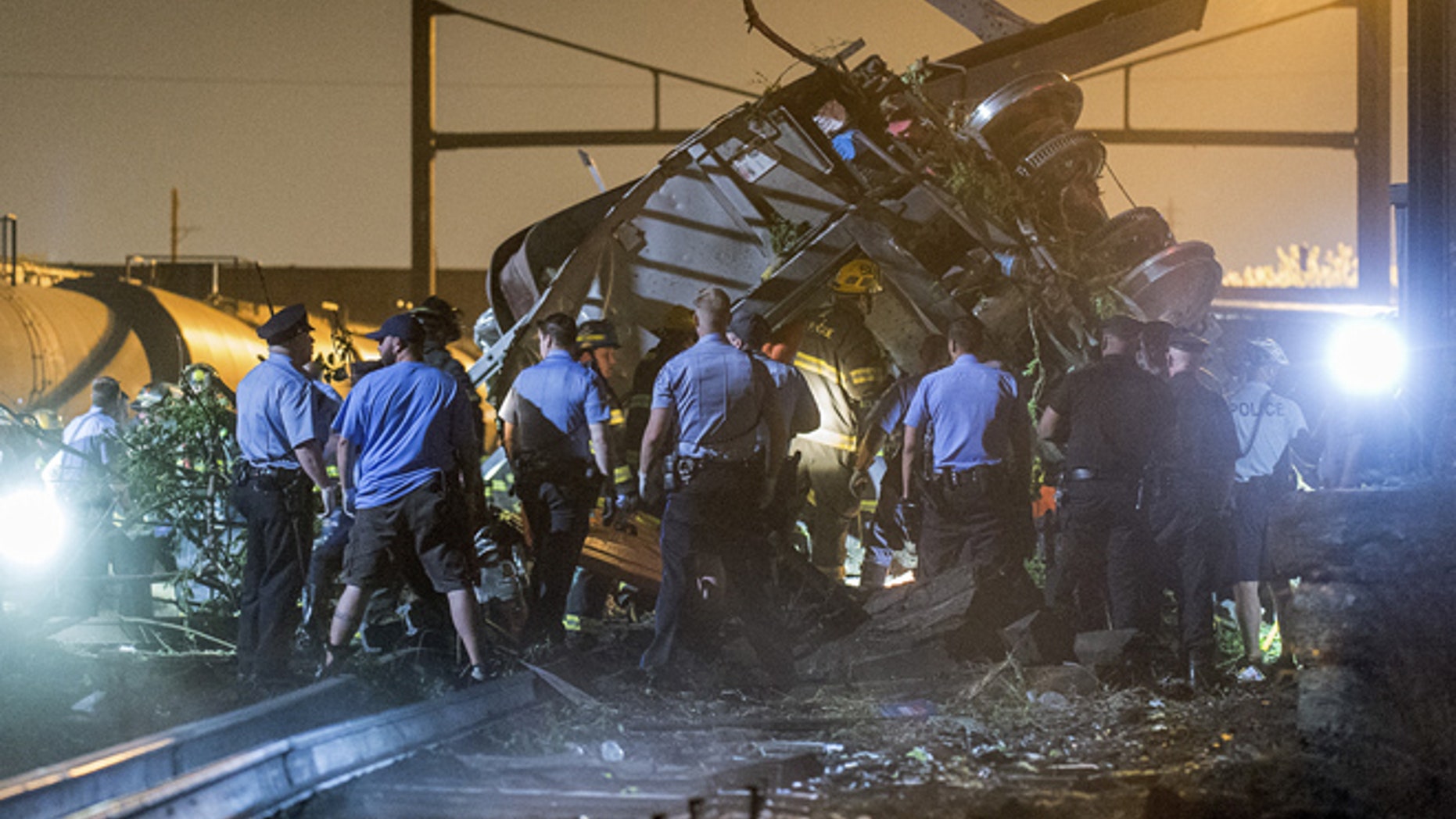 FILE 2015: Rescue workers search for victims in the wreckage of a derailed Amtrak train in Philadelphia