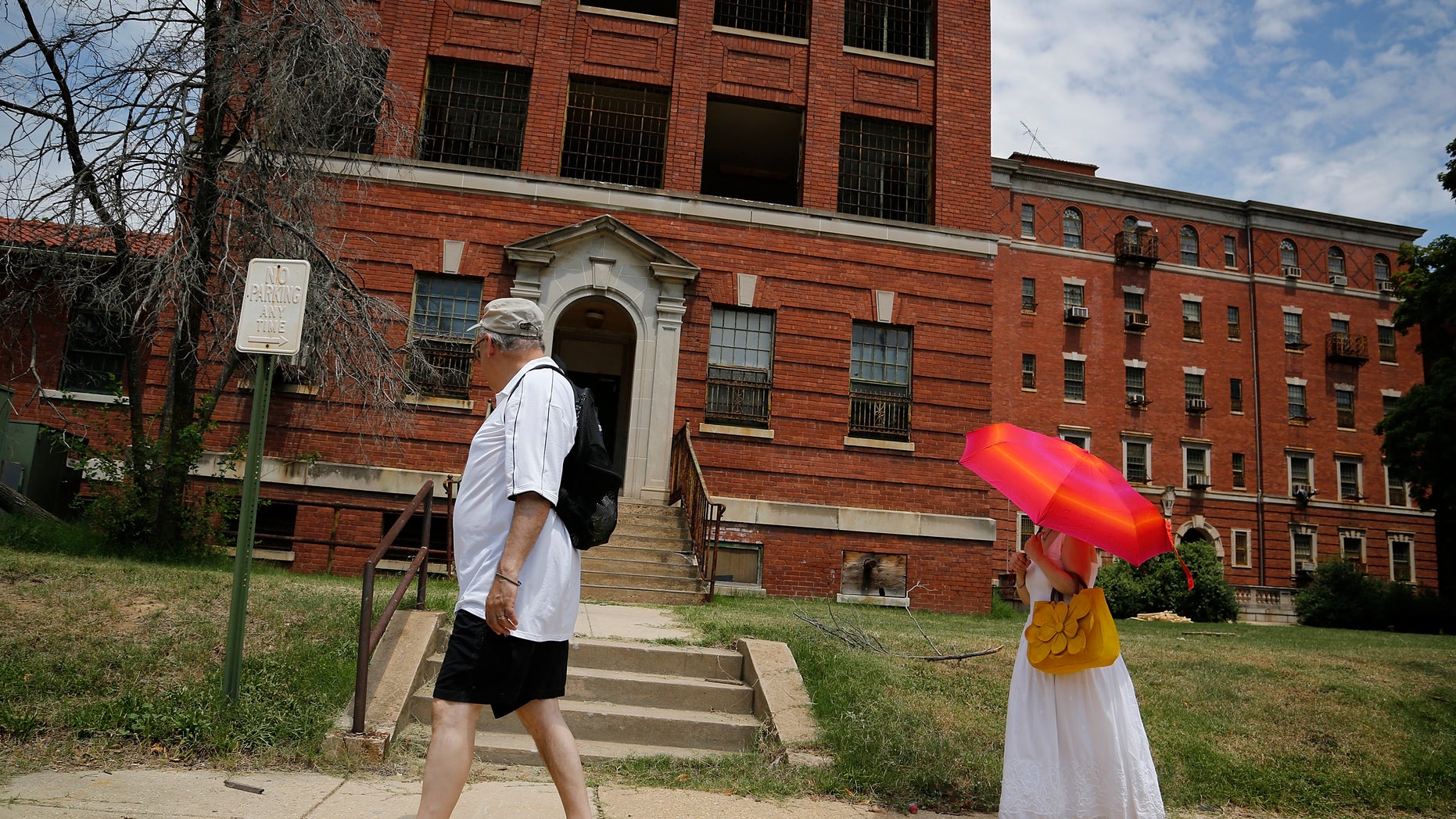 FILE: Visitors view the abandoned buildings on the grounds of the east campus of the historic St. Elizabeth's Hospital in Washington.