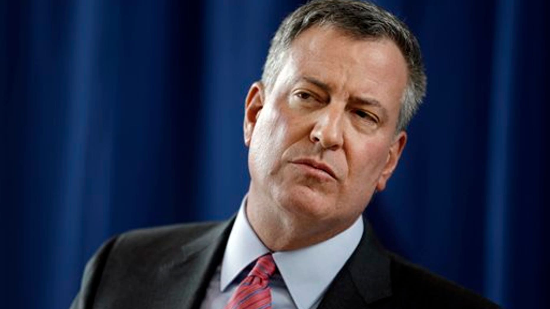 FILE - In this Feb. 25, 2014 file photo, New York City Mayor Bill de Blasio listens to a question during a news conference at P.S. 130 in New York.