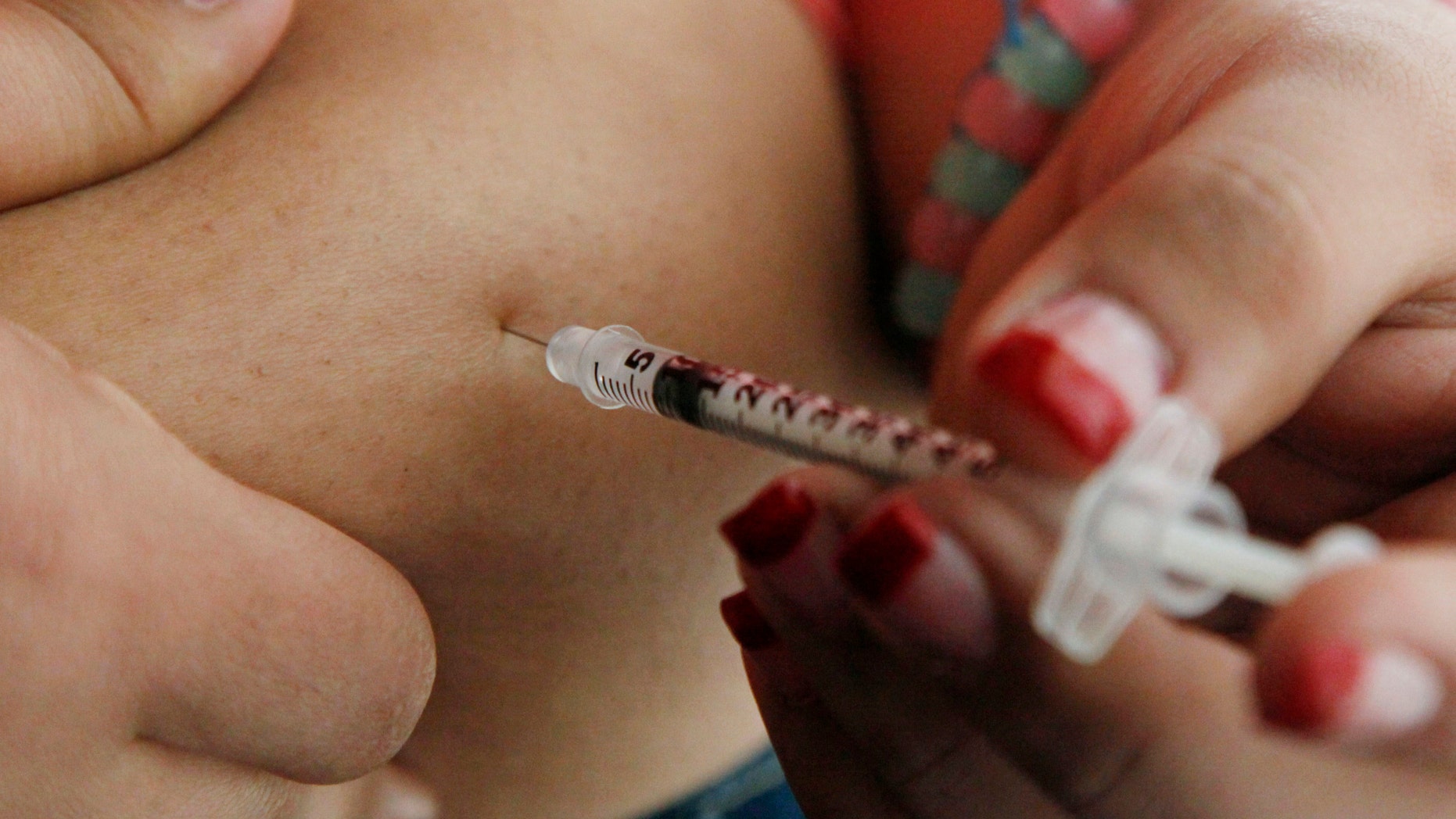 April 29, 2012: In this file photo a woman diagnosed with diabetes gives herself an injection of insulin at her home in the Los Angeles suburb of Commerce, Calif.