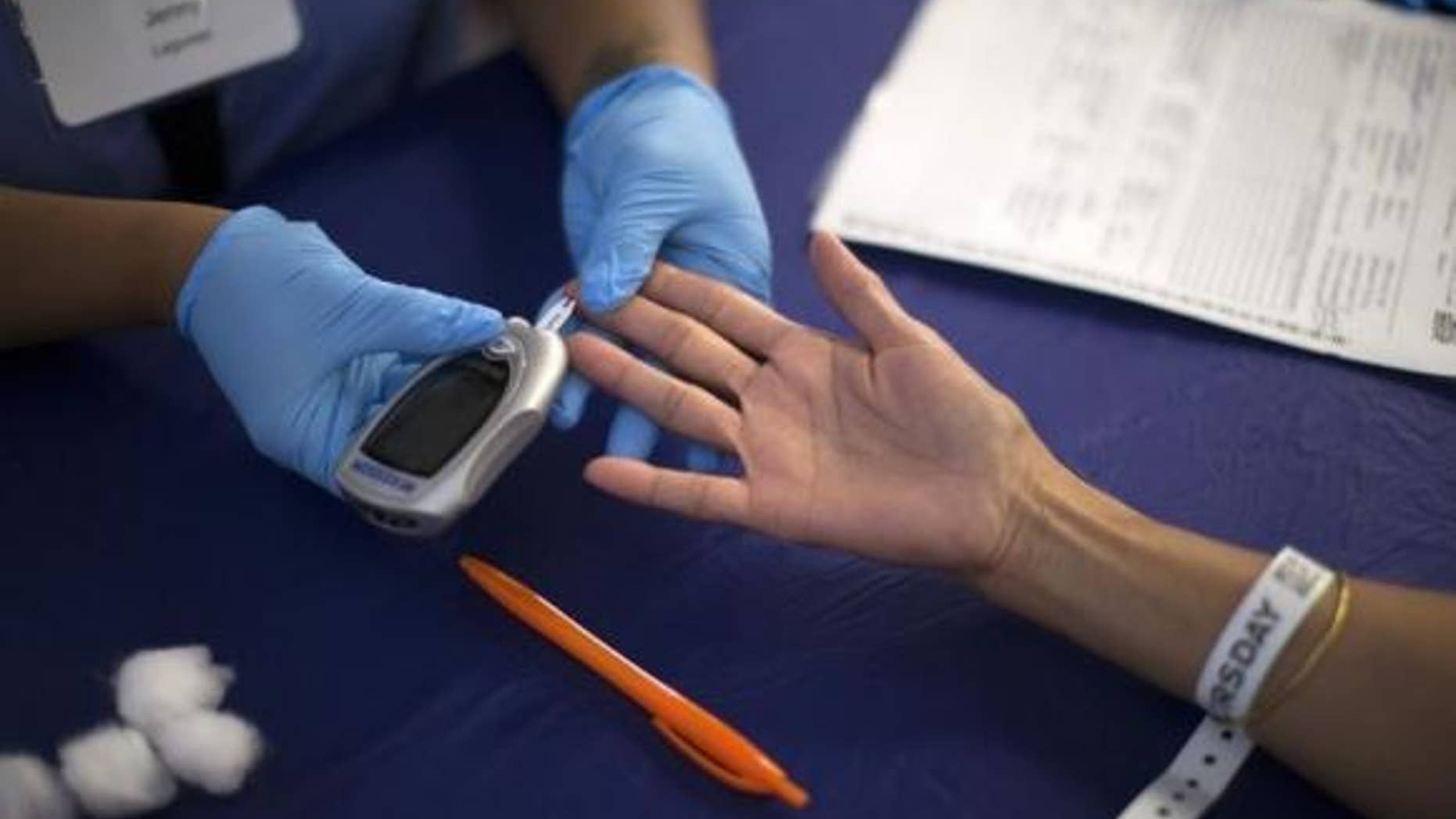 Sept. 11, 2014: A person receives a test for diabetes during Care Harbor LA free medical clinic in Los Angeles, California.